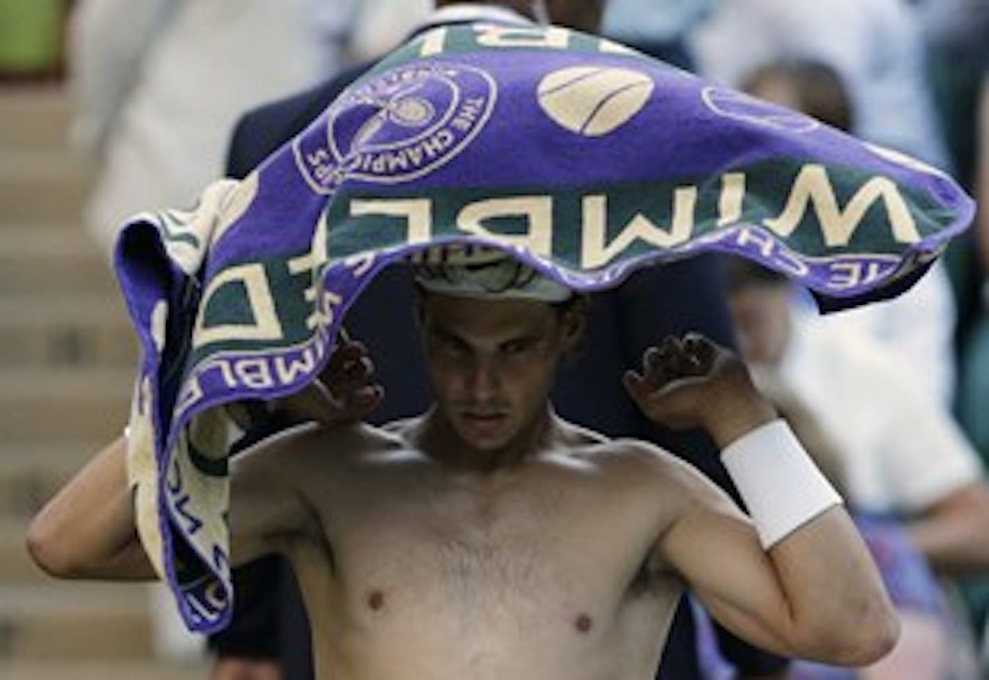 Too hot for a shirt? Rafael Nadal thought so. Also too hot for a victory; he was bounced at Wimbledon. /AP Photo