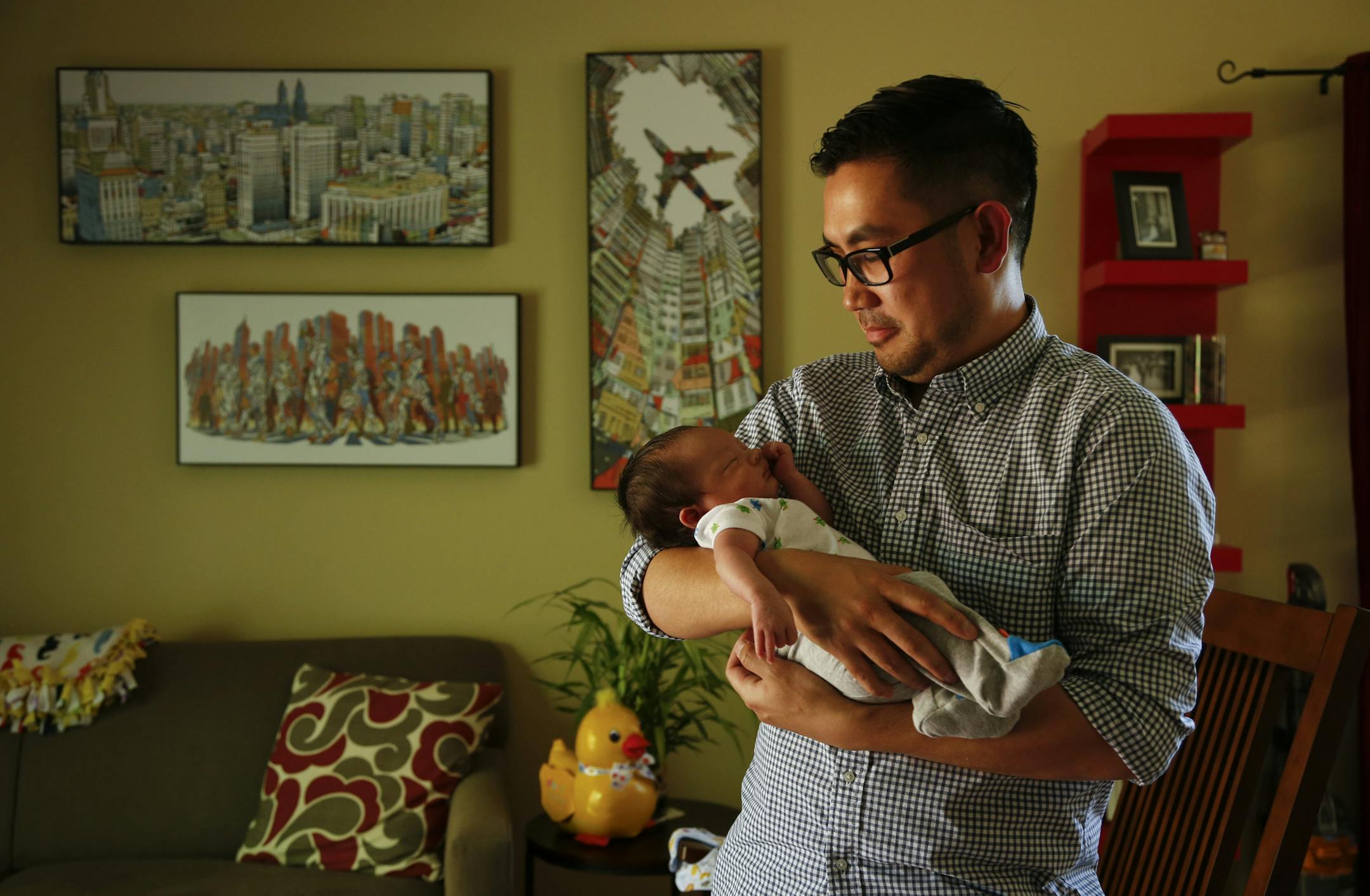 Thuyet Nguyen with his son, Elliot. ] JEFF WHEELER ‚Ä¢ jeff.wheeler@startribune.com Thuyet Nguyen and his son, Elliot, photographed in their Brooklyn Park home Friday afternoon, May 23, 2014.