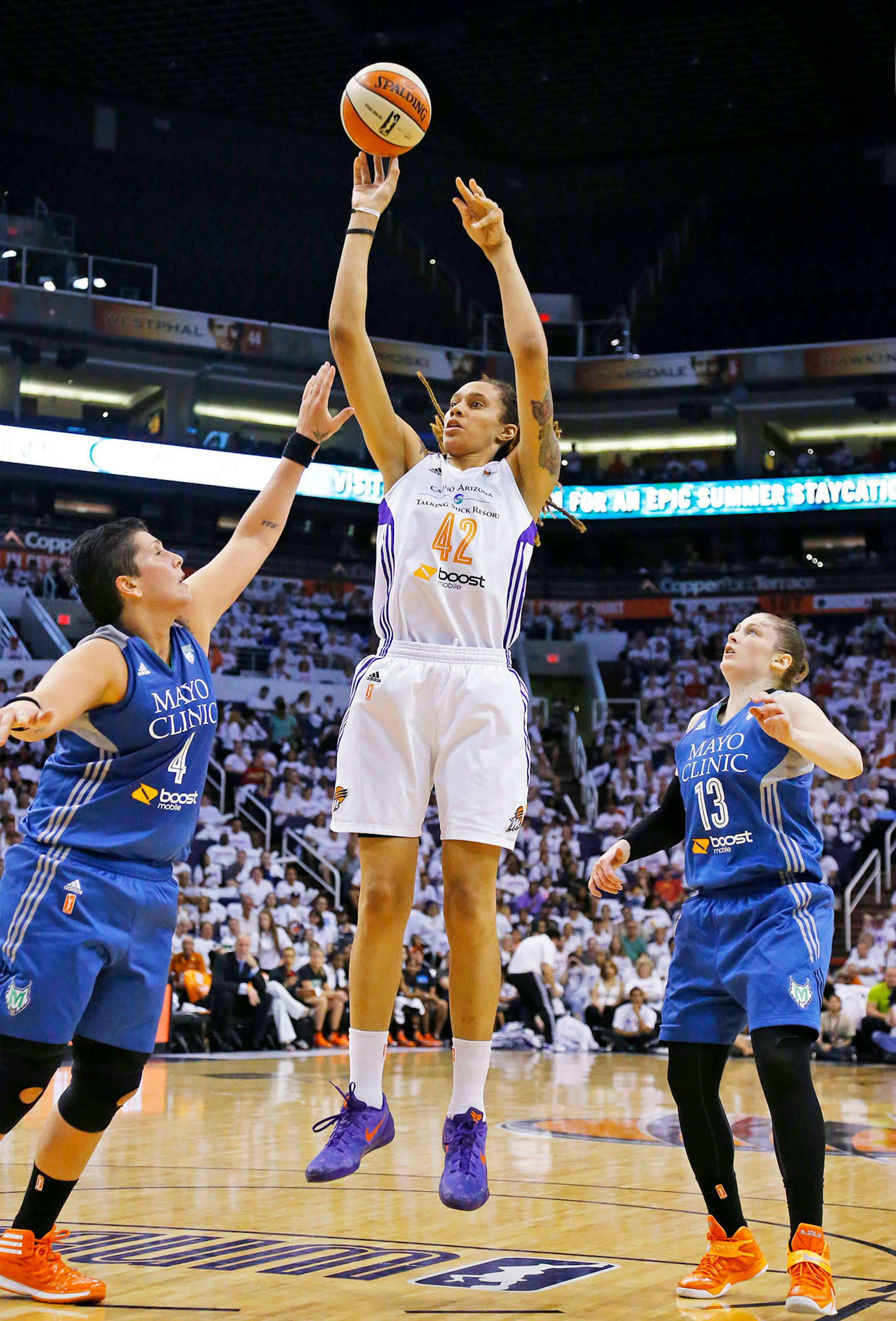 Phoenix Mercury center Brittney Griner (42) shoots against Minnesota Lynx center Janel McCarville (4) and Lindsay Whalen during the first half of Game 1 of the WNBA Western Conference finals Friday, Aug. 29, 2014 in Phoenix, Ariz.