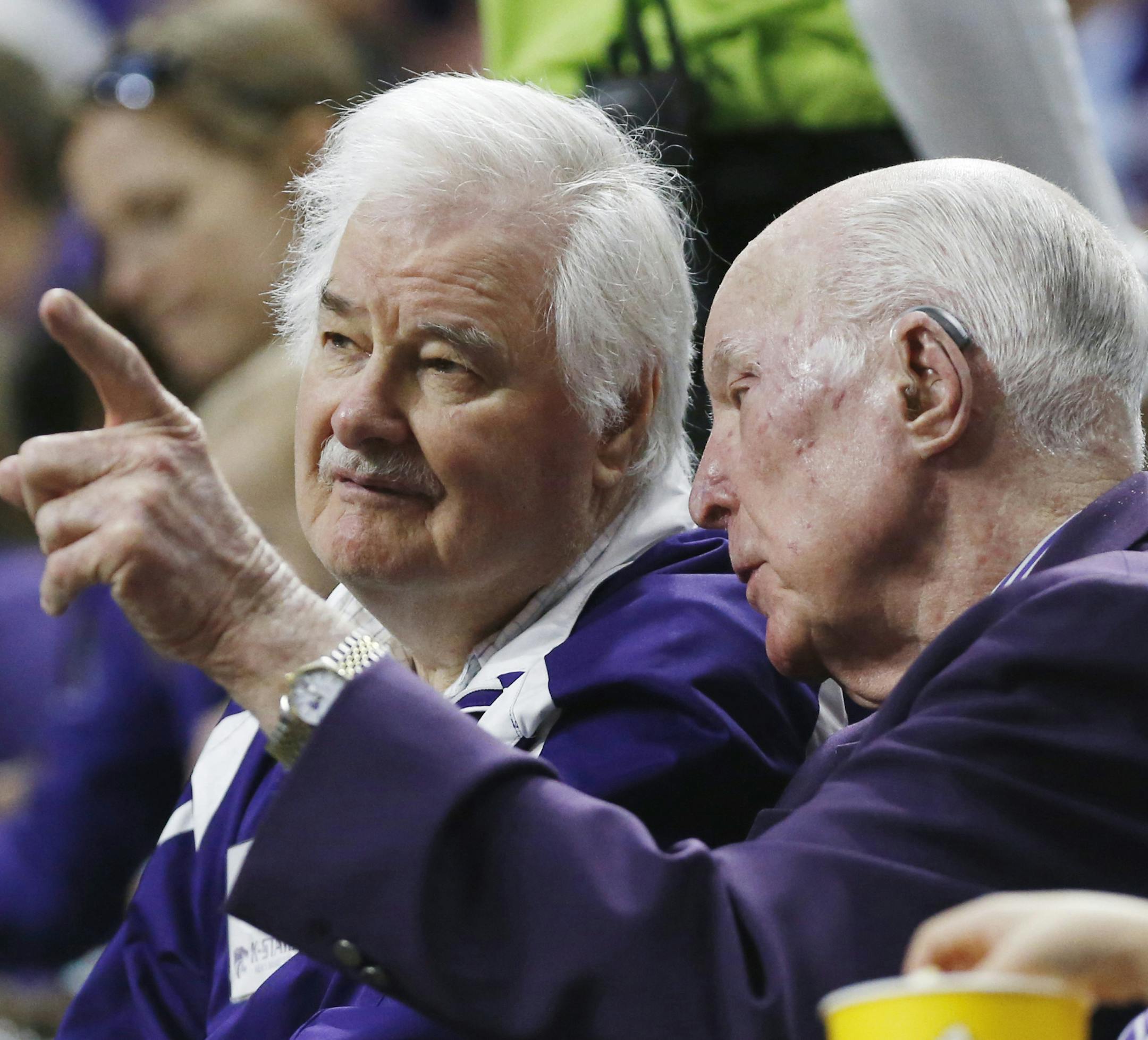 Former Kanas State coach Tex Winter (K-State 1953-1968), left, and Ernie Barrett (K-State 1948-1951) share a moment during a visit from Oklahoma State at Bramlage Coliseum in Manhattan, Kan., on January 24, 2015. Winter, the Hall of Fame coach whose teachings of the triangle offense helped spearhead six Chicago Bulls championships in the 1990s, died Wednesday, Oct. 10, 2018, at 96. (Bo Rader/Wichita Eagle/TNS) ORG XMIT: 1242422