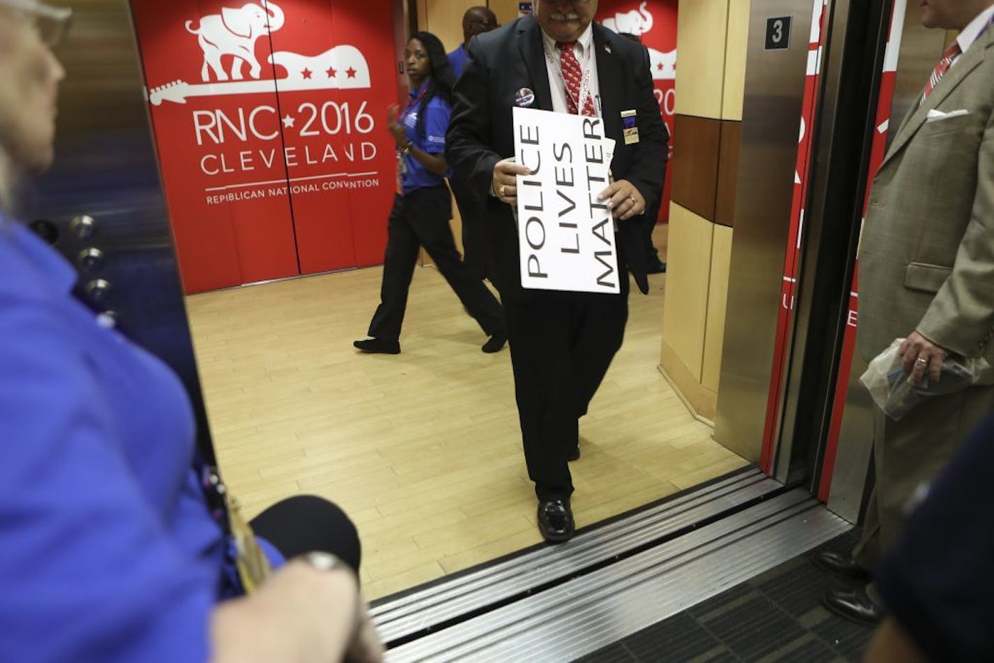 A man with a "Police Lives Matter" sign exits an elevator on the final day of the Republican National Convention at the Quicken Loans Arena in Cleveland, July 21, 2016.