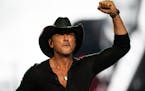 Country music star Tim McGraw pumps his fist while performing at Xcel Energy Center in St. Paul, Minn on Saturday during his Standing Room Only Tour. 