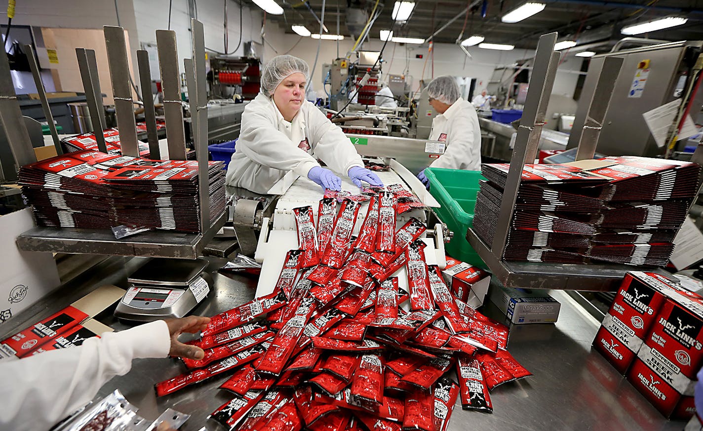 Workers processed Jack Links beef jerky in the packaging area.