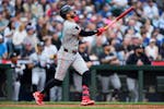 The Twins' Carlos Correa follows through on a two-run home run against Mariners starting pitcher Logan Gilbert during the sixth inning Friday in Seatt