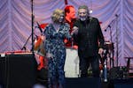 Robert Plant and Alison Krauss walk onto the stage Friday, June 7, 2024 at the Mystic Lake Casino amphitheater in Prior Lake, Minn.