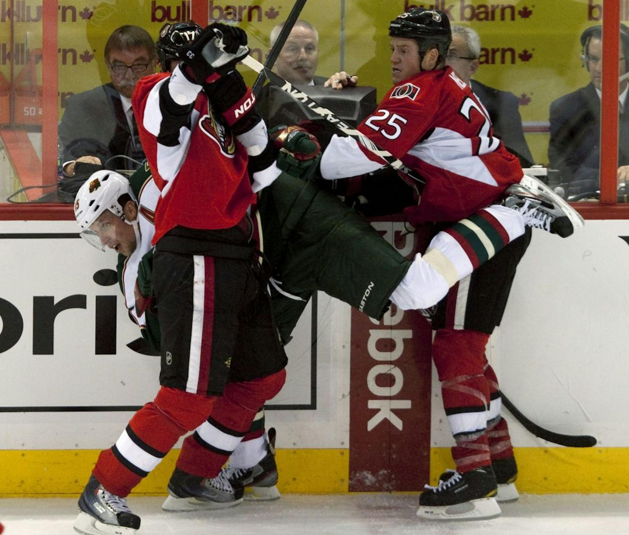 Dany Heatley, making his Ottawa debut as a Wild player, received special attention from the Senators' Chris Neil, right, and Filip Kuba during the second period Tuesday. Heatley had an assist in the Wild's 4-3 shootout loss.