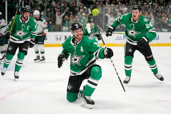 Dallas Stars center Tyler Seguin (91) celebrates with Jamie Benn, left, and Roope Hintz (24) after scoring against the Minnesota Wild during the first
