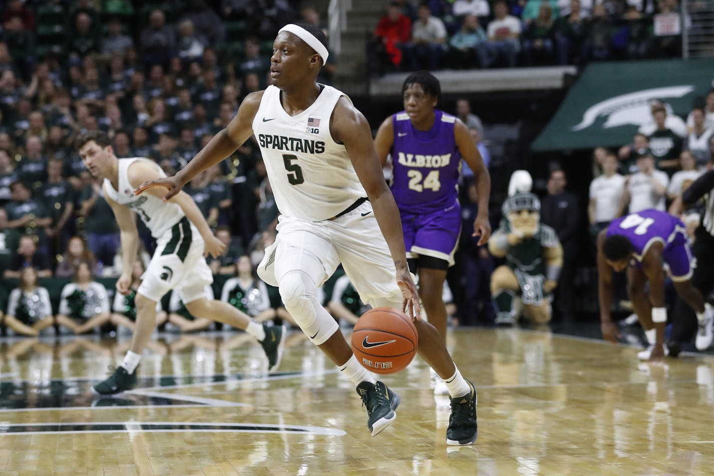 Michigan State guard Cassius Winston (5) brings the ball up court during the second half of an NCAA college exhibition basketball game against Albion, Tuesday, Oct. 29, 2019, in East Lansing, Mich. (AP Photo/Carlos Osorio) ORG XMIT: otkco107