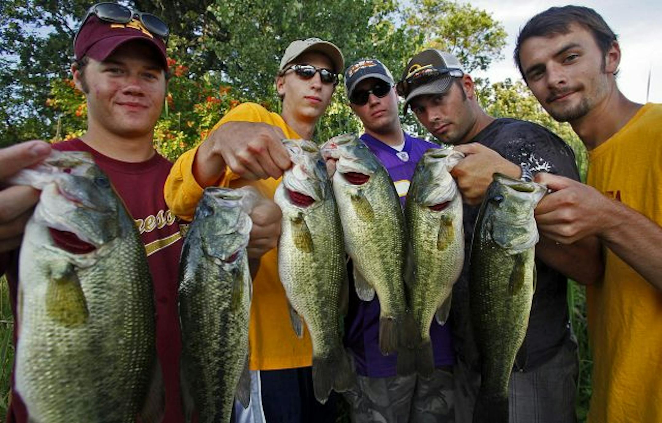 Holding up Sunday's catch of bass at Bald Eagle Lake were, from left, Eric Sanft, Alex Batts, Corey Vance, Jeff Hoberg and Jeff Batts. The University Bass Fishing Club, a club at the University of Minnesota, doesn't have many members, although no one is excluded from competing.