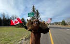 Visit Cook County Executive Director Linda Jurek dressed as Murray the Moose to welcome Canadian visitors to Minnesota on Monday, the first day the U.