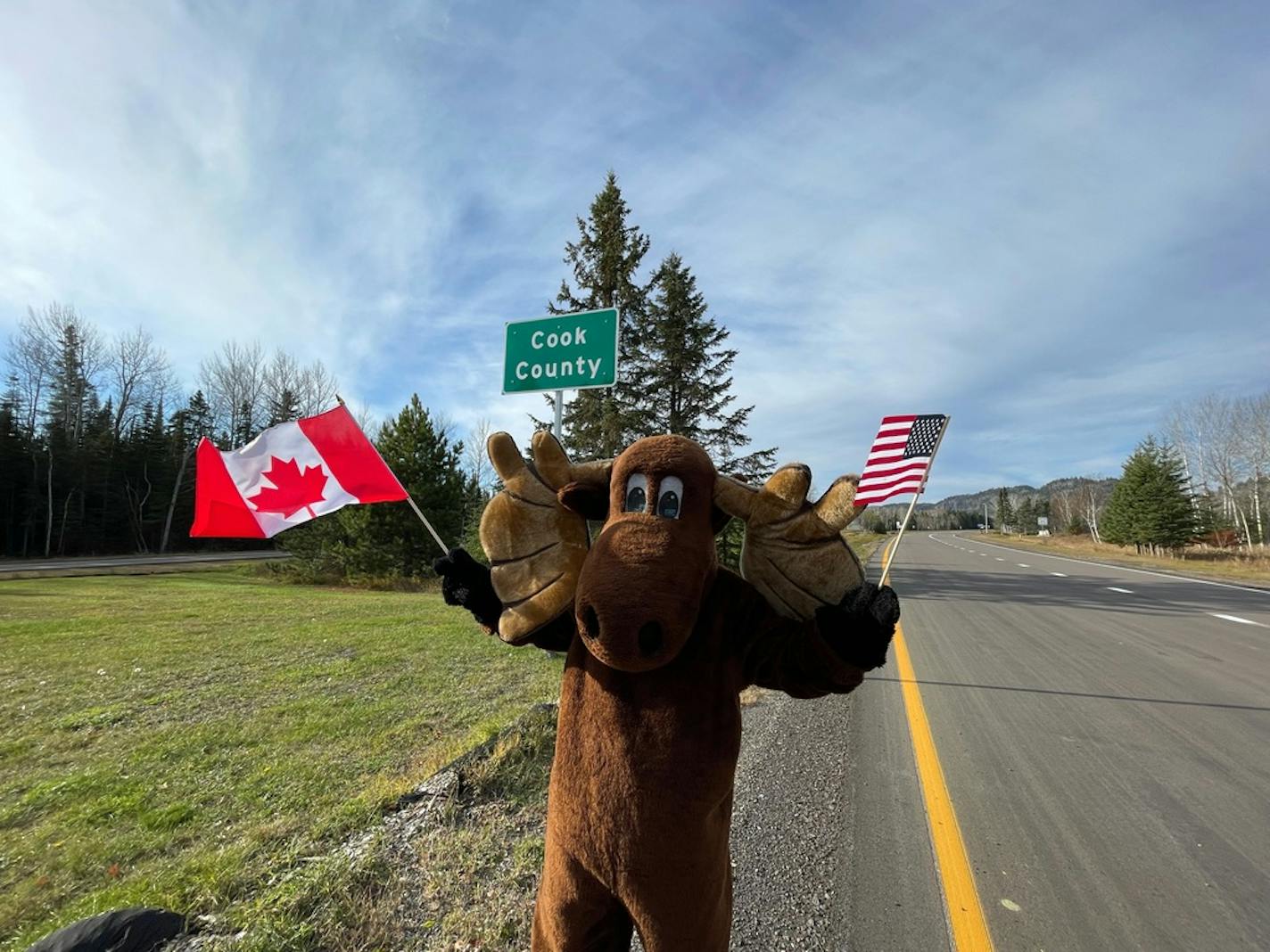 Visit Cook County Executive Director Linda Jurek dressed as Murray the Moose to welcome Canadian visitors to Minnesota on Monday, the first day the U.S. border opened to Canada since March 2020. (Provided by Visit Cook County)