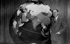 John Cowles, publisher, shows off the Star Tribune Globe in about 1951.