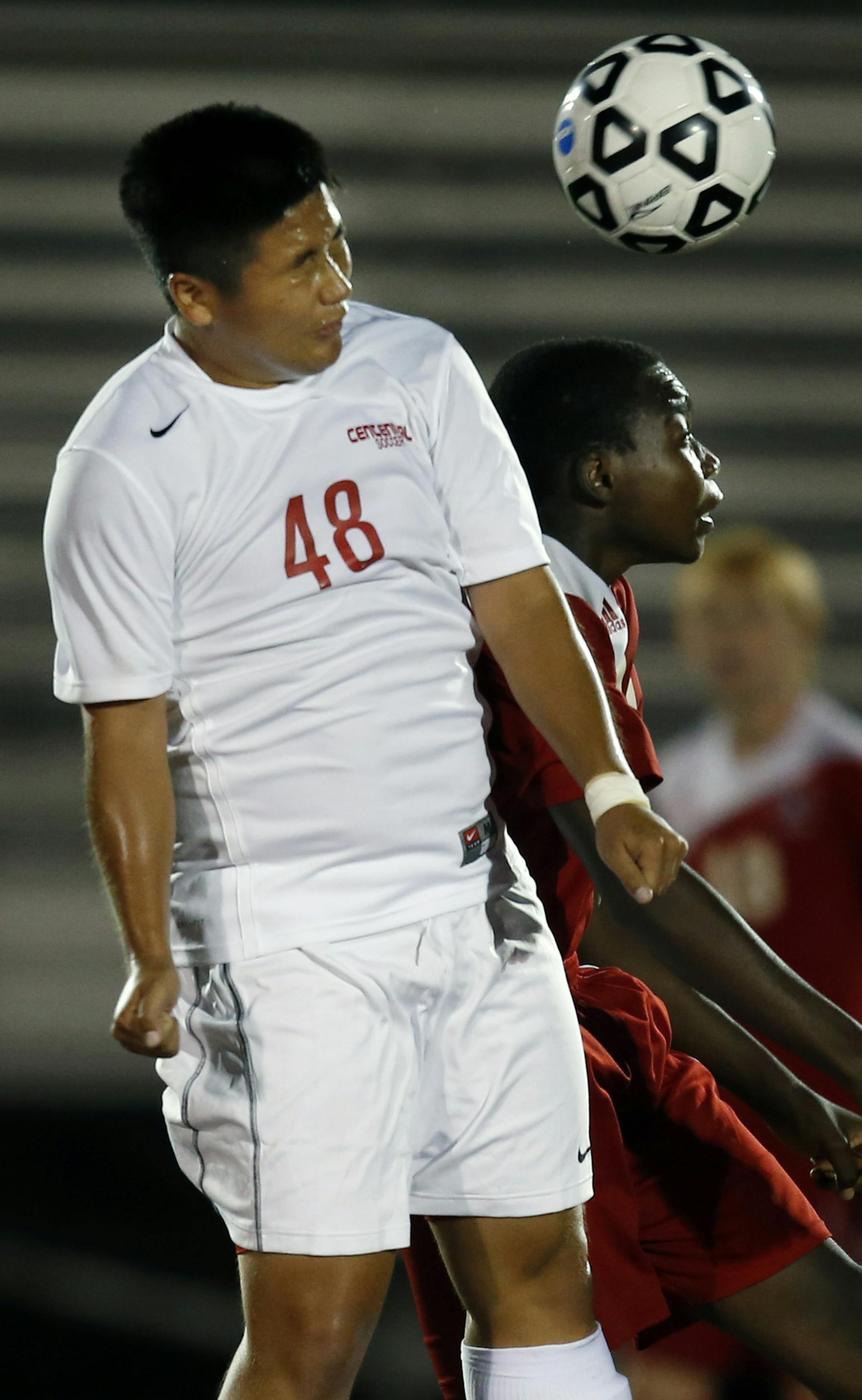 At a varsity boys soccer game between Centennial and Coon Rapids in Lino Lakes, Lotsimin Yang(48) battled for a header against forward Gael Ntambwen(19) of Coon Rapids . ] Richard Tsong-Taatarii/rtsong-taatarii@startribune.com