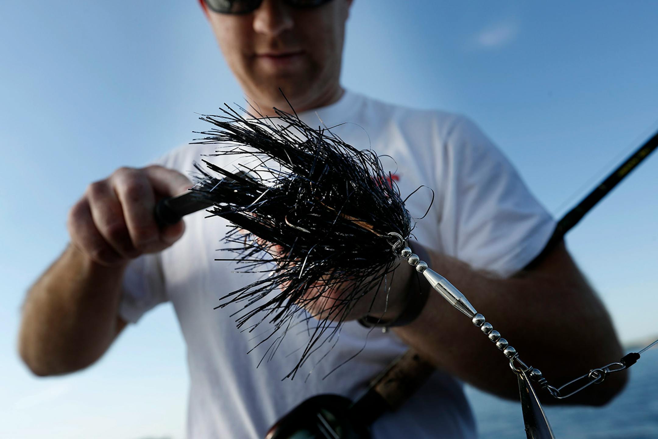 Fishing guide Travis Frank sharpened the hooks on a Bucktail lure. The Bucktail lure is one of many that he used to fish for Muskie. Frank sharpens his hooks every time he fishes for Muskie.