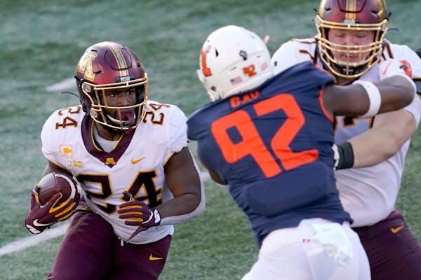 Minnesota running back Mohamed Ibrahim carries the ball during the first half