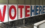 A "Vote Here" sign marks the entrance on Thursday, Sept. 20, 2018, to an early voting station in downtown Minneapolis for Friday's opening of early vo