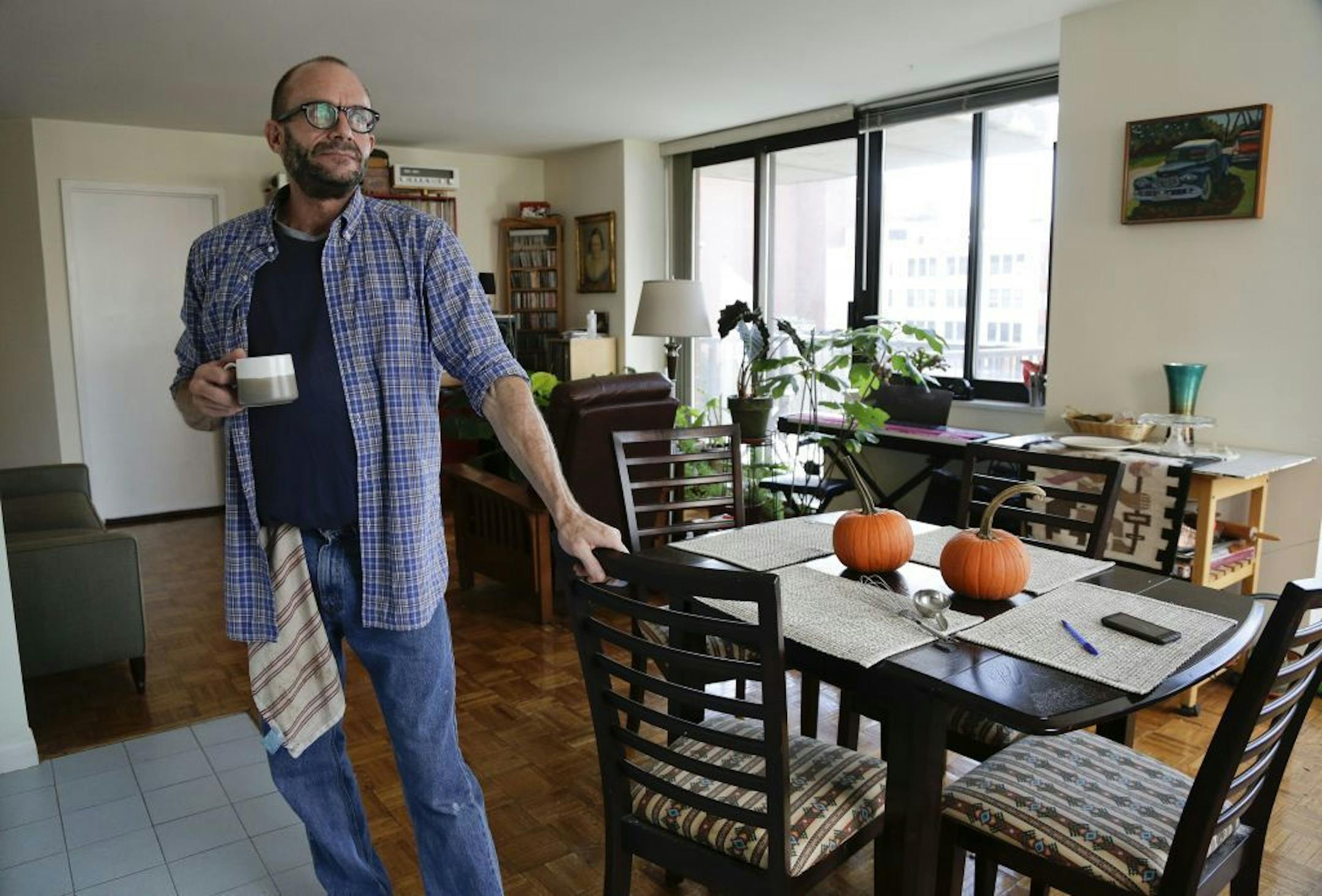 In this photo taken on Oct. 16, 2014 photo, Jim Albaugh talks about his living arrangements in the New York apartment he shares with two roommates. Albaugh could be thought of as just one of the working poor, untold millions in the baby boomer generation who are not prepared for retirement. But he represents something more as one of thousands of gay and lesbian baby boomers confronting a retirement of greater financial hardship than his straight peers.
