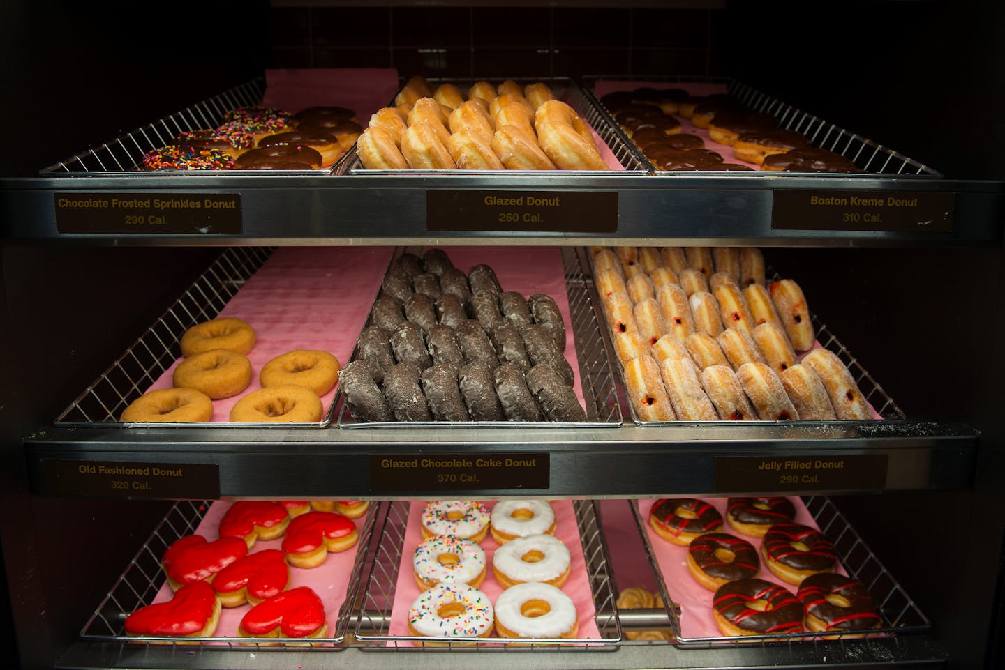 Doughnuts are displayed for sale at a Dunkin Donuts Inc. store in Manhattan, New York, U.S., on Wednesday, Feb. 5, 2014. Dunkin Donuts Inc. is scheduled to release earnings figures on Feb. 6. Photographer: Craig Warga/Bloomberg