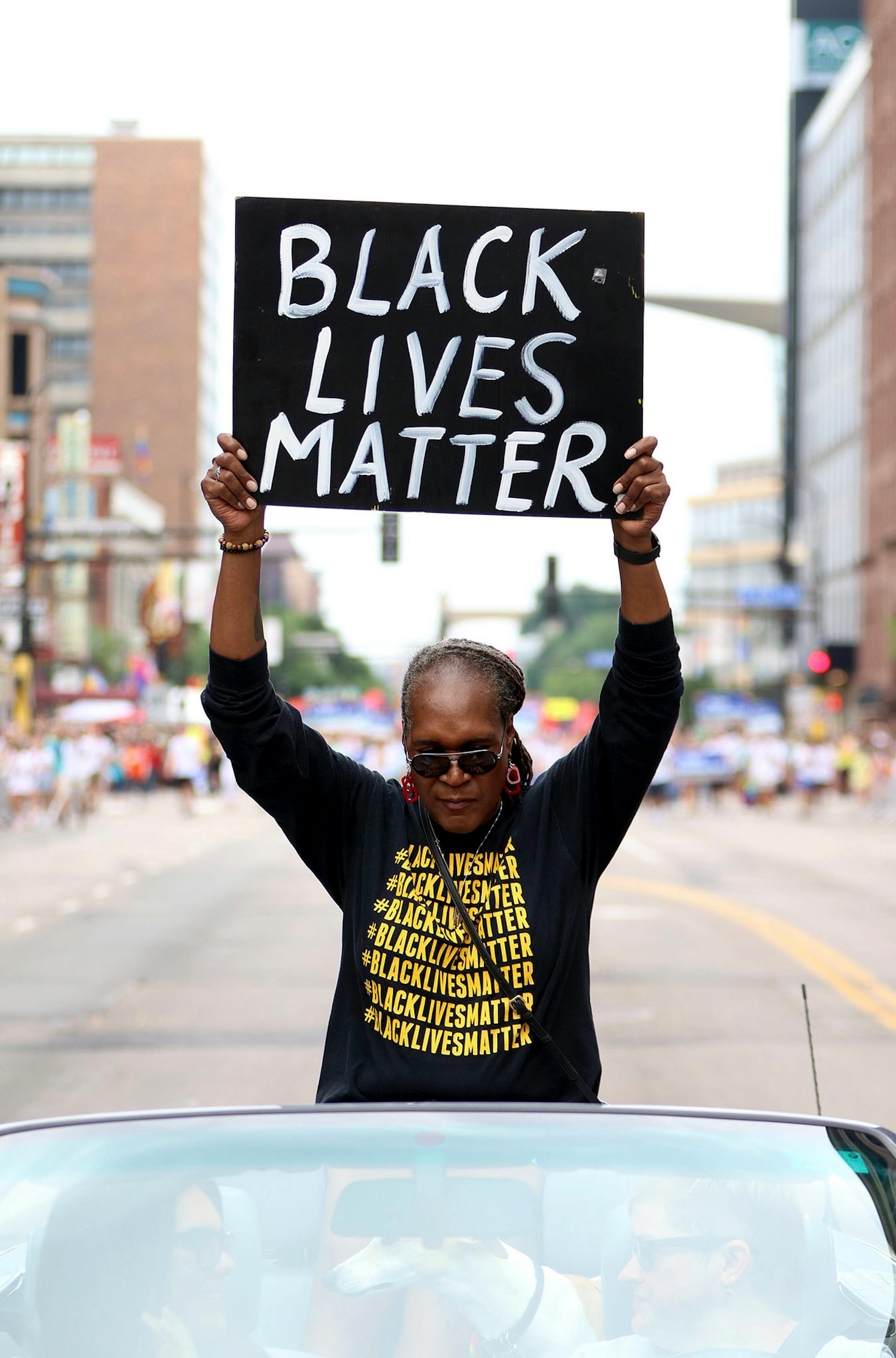 Andrea Jenkins, the city council vice president, held up a "Black Lives Matter" sign to thunderous applause as she rode down Hennepin avenue, Sunday, June 24 2018.