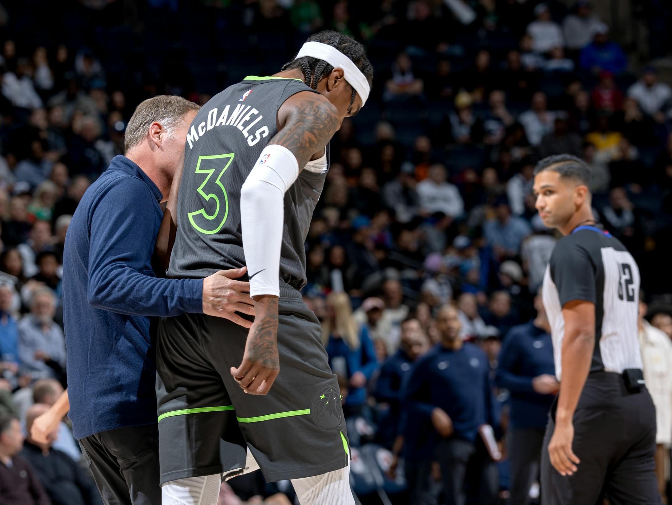 Jaden McDaniels (3) of the Minnesota Timberwolves is helped off the court in the first quarter Monday, November 20, 2023, at Target Center in Minneapolis, Minn. ] CARLOS GONZALEZ • carlos.gonzalez@startribune.com