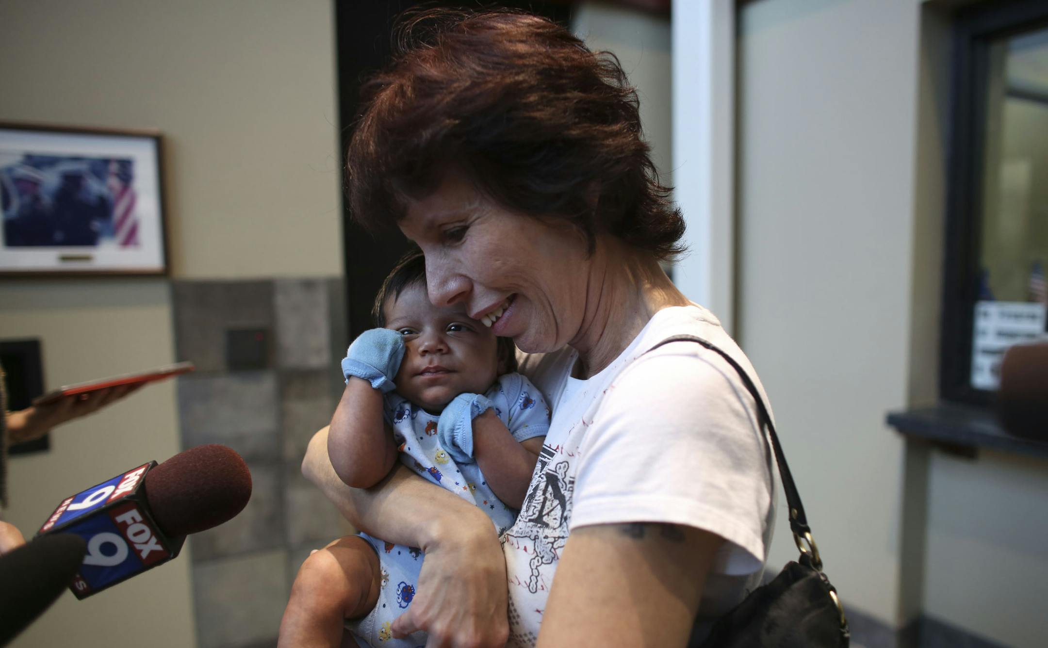 Ester Baker held her only grandson Elijah Alonzo, two months old, as she talked to the media after he was returned safely at police headquarters in Brooklyn Park, Min., Tuesday, June 18, 2013. Baker was going to bring her grandson to her daughter Christina Alonzo at a local hospital where she was having tests done. ] (KYNDELL HARKNESS/STAR TRIBUNE) kyndell.harkness@startribune.com