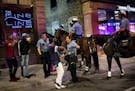 Minneapolis Police officers worked on clearing a group of men from First Avenue North in downtown Minneapolis after closing time early Sunday morning.