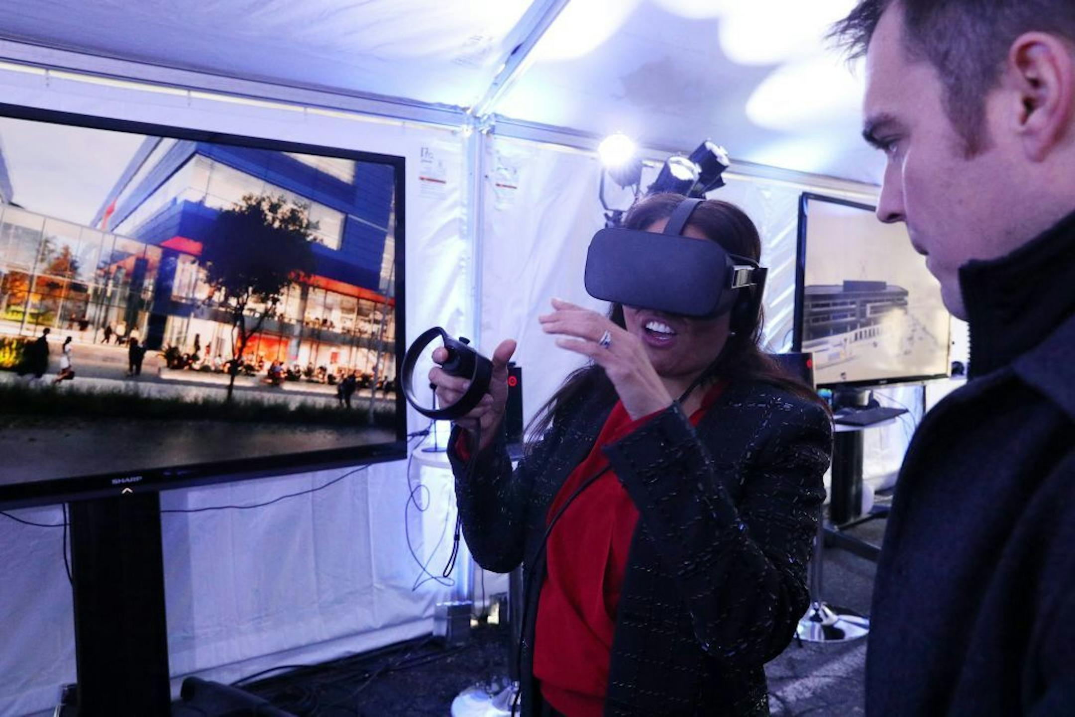 Taylor Cupp with Mortenson showed Joselyn Raymundo a virtual reality walkthrough of Discovery Square in a heated tent following an outdoor groundbreaking.