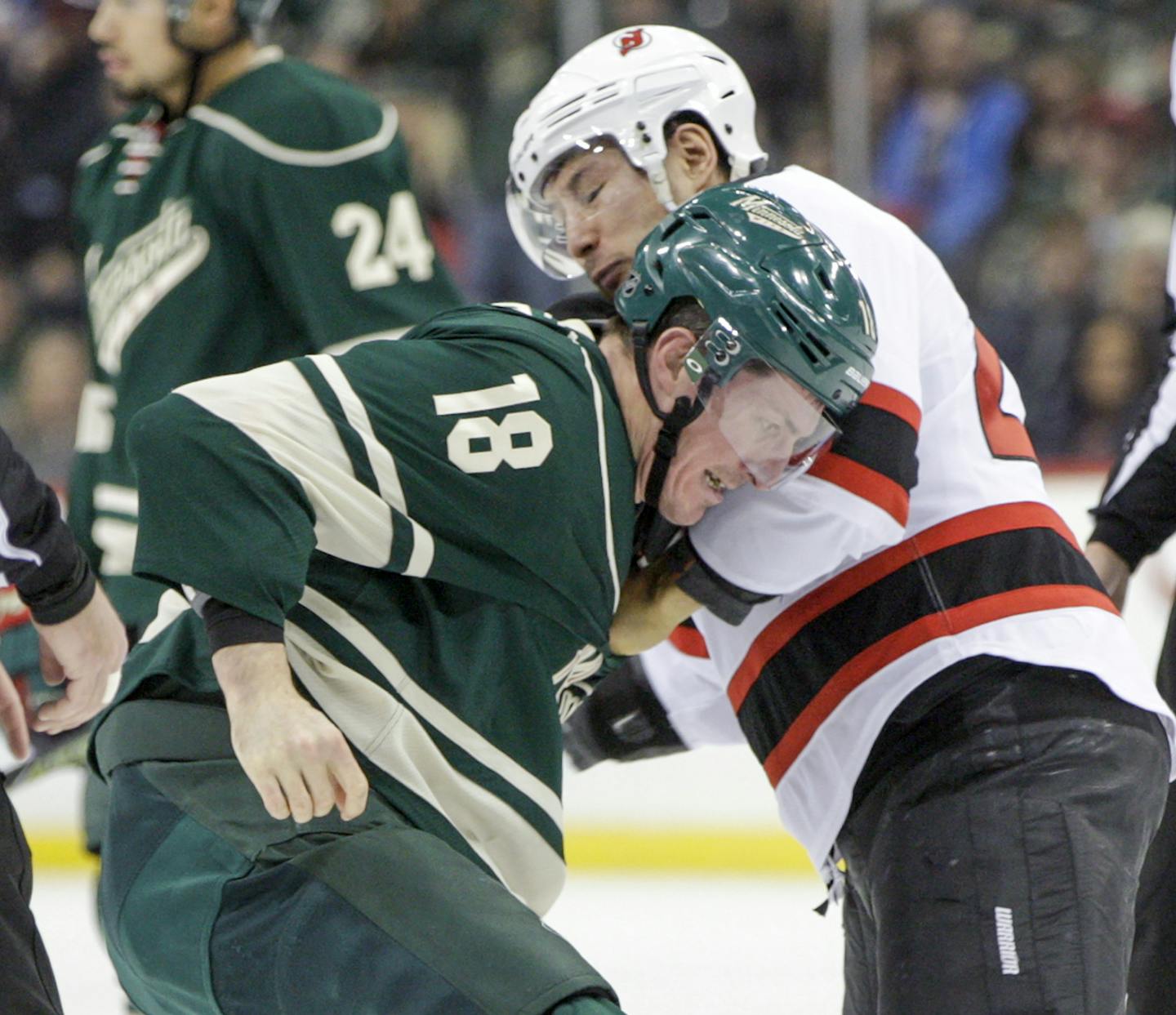 Minnesota Wild' Ryan Carter (18) and New Jersey Devils' Jordin Tootoo (22) both received two-minutes for fighting during the second period of an NHL hockey game, Sunday, Jan. 10, 2016, in St. Paul, Minn. The Devils won 2-1. (AP Photo/Paul Battaglia)