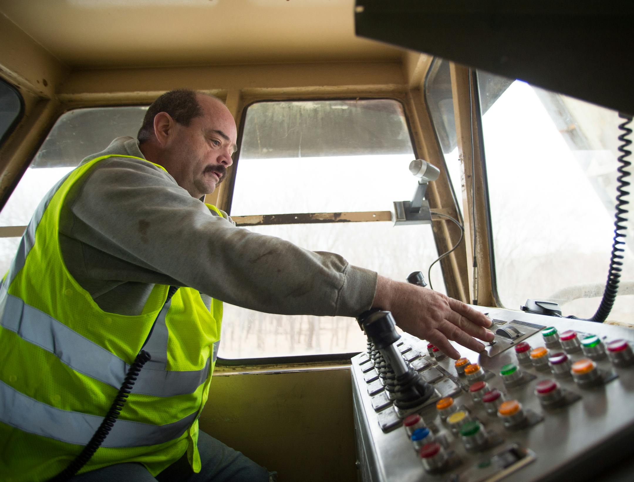 Jerry Falnes, with CHS, demonstrates the operation of a grain spout on Friday morning at the CHS River Barge Loading Facility. ] AARON LAVINSKY • aaron.lavinsky@startribune.com Photographing the process of unloading grain from trucks onto river barges at the CHS Grain Terminal in Savage on Friday, November 7, 2014.