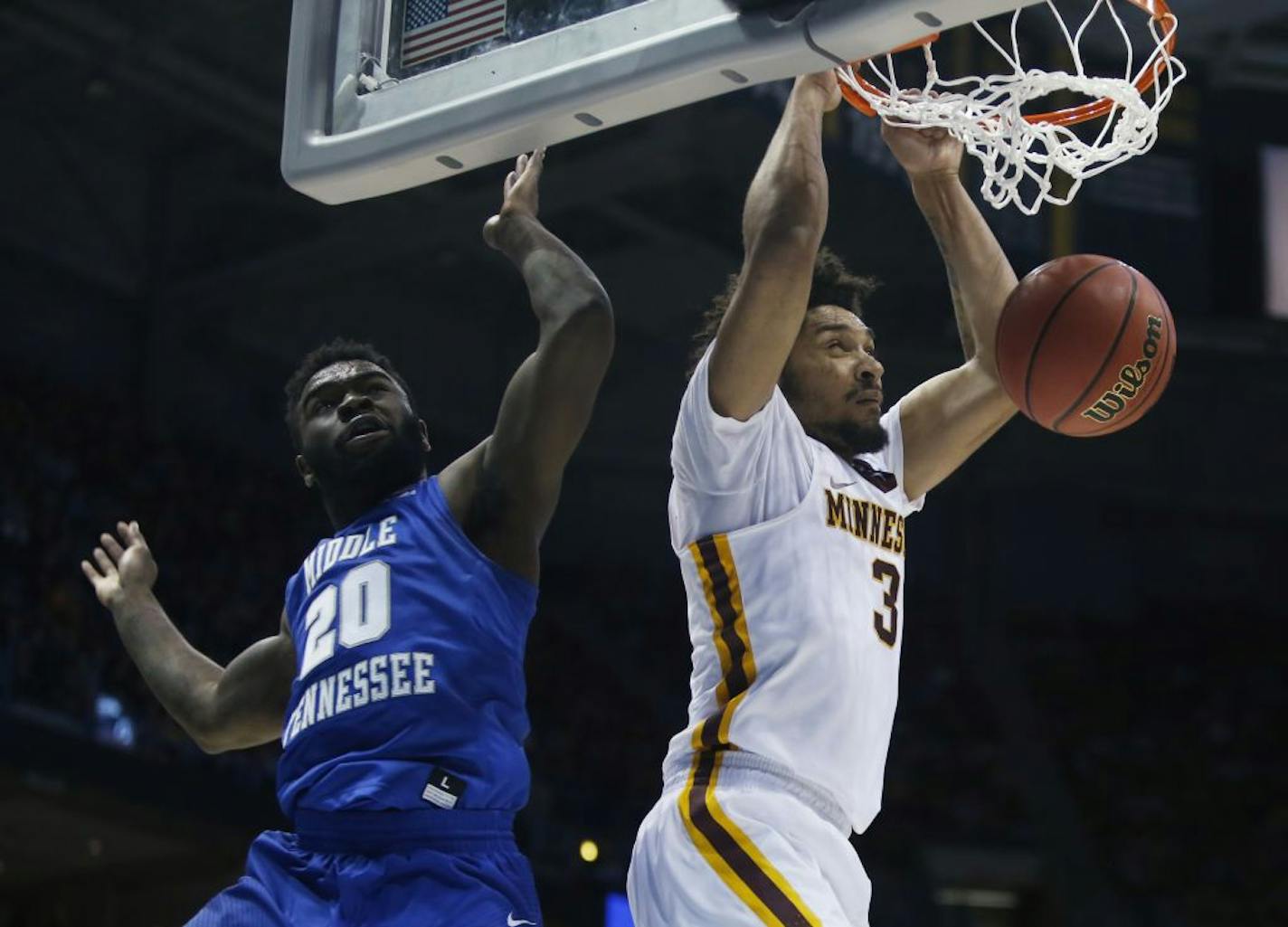 Minnesota's Jordan Murphy dunks past Middle Tennessee State's Giddy Potts during the second half of an NCAA college basketball tournament first round game Thursday, March 16, 2017, in Milwaukee.