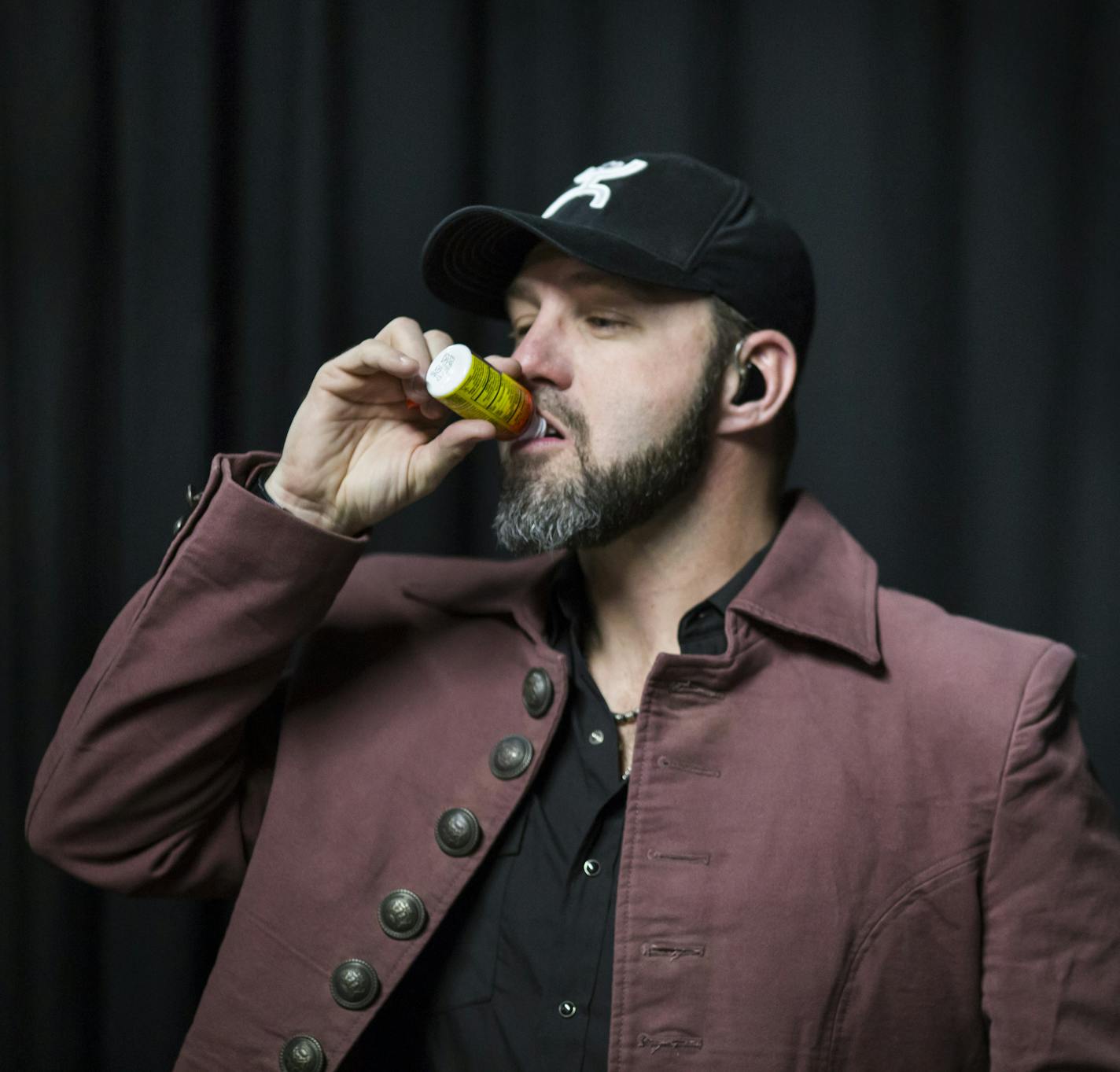 Chris Hawkey tipped back a 5 Hour Energy before opening for the Gear Daddies at the Medina Entertainment Center in December.