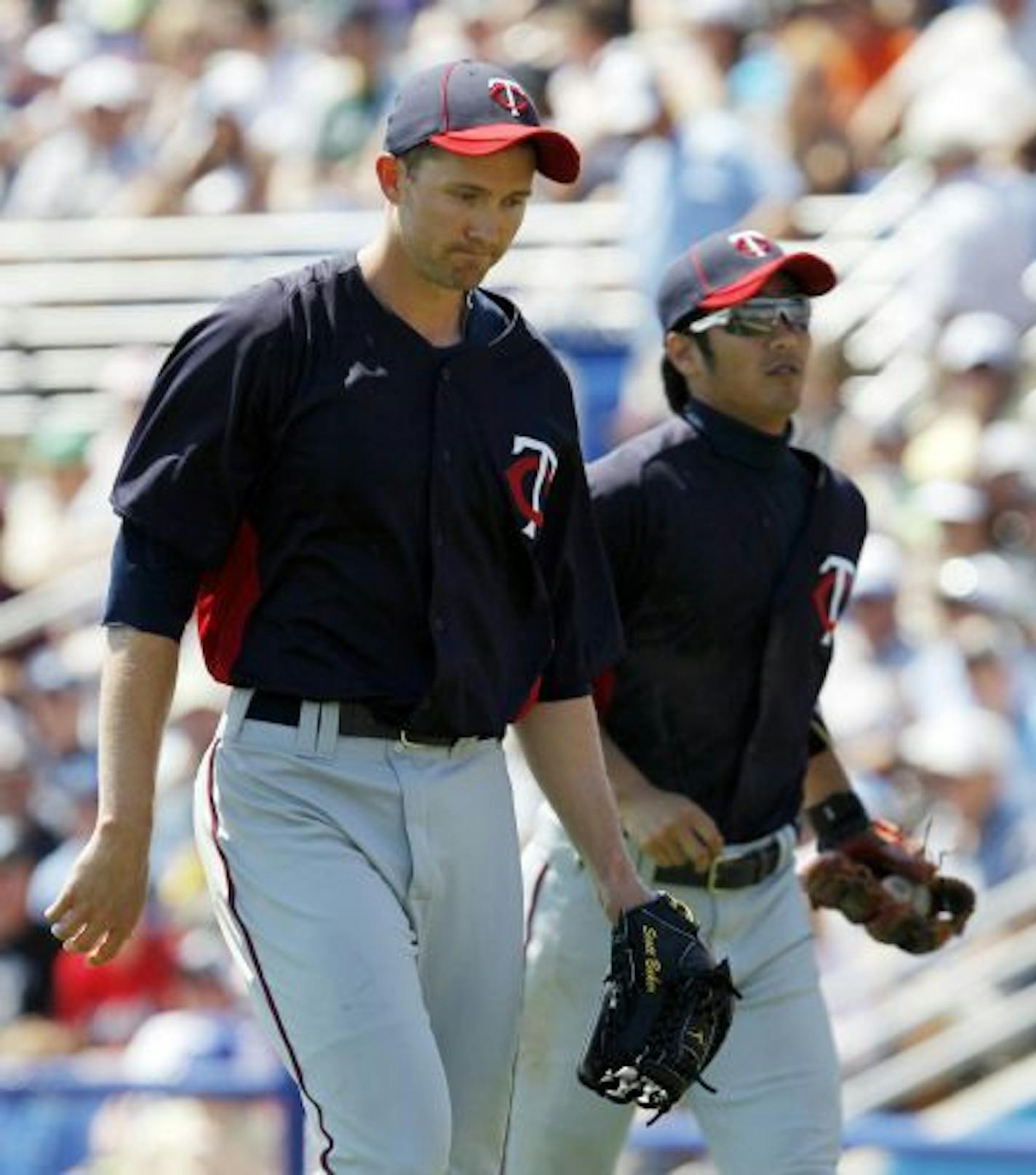 The Twins' starting rotation has been settled, with righthander Scott Baker (left, with Tsuyoshi Nishioka) in, and righthander Kevin Slowey the odd man out.