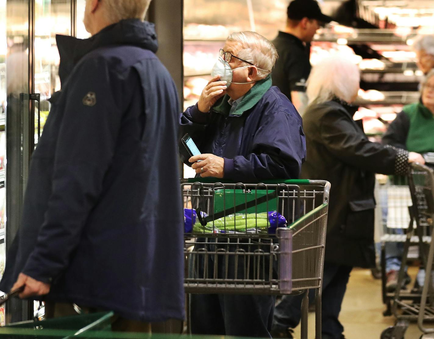 Shopper Merlin Smith, 82, of Edina, with mask, navigates the aisles of Lunds and Byerlys in Edina last week during an early morning hour devoted to older shoppers and shoppers with health conditions. (DAVID JOLES/Star Tribune)