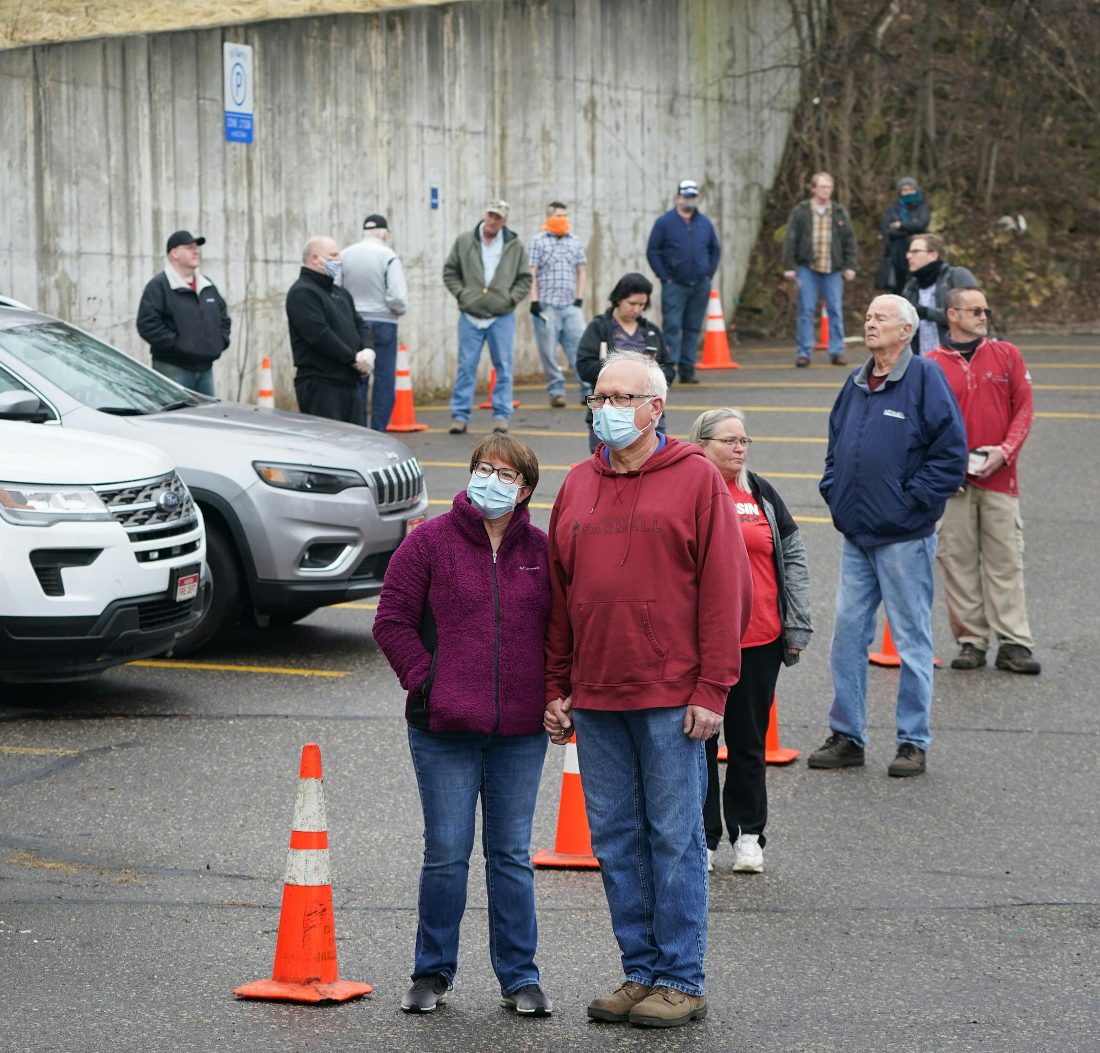 Brenda and Mike Drinken of Hudson, Wisconsin held hands as they waited in line to vote Tuesday morning. Voters in Hudson, Wisconsin were allowed into the firehouse one by one to vote in Tuesday's primary. They lined up next to cones in the parking lot that were ten feet apart. They started at a hand washing station and voting equipment was sanitized after each voter. ] GLEN STUBBE • glen.stubbe@startribune.com Tuesday, April 7, 2020 Wisconsin's primary election goes on on Tuesday, despite