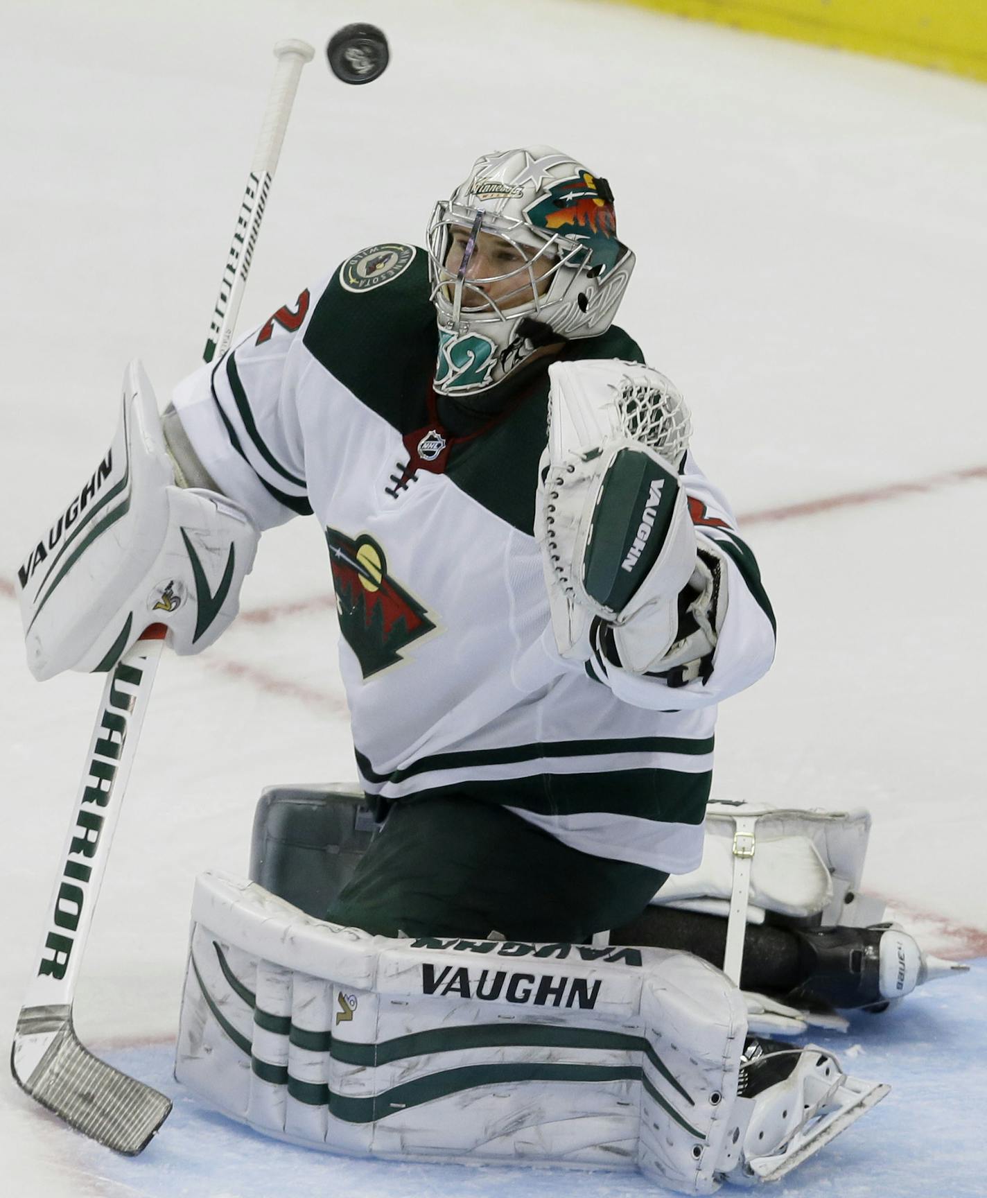 Minnesota Wild goalie Alex Stalock deflects a shot during the second period of a preseason NHL hockey game against the Dallas Stars in Dallas, Tuesday, Sept. 26, 2017. (AP Photo/LM Otero)