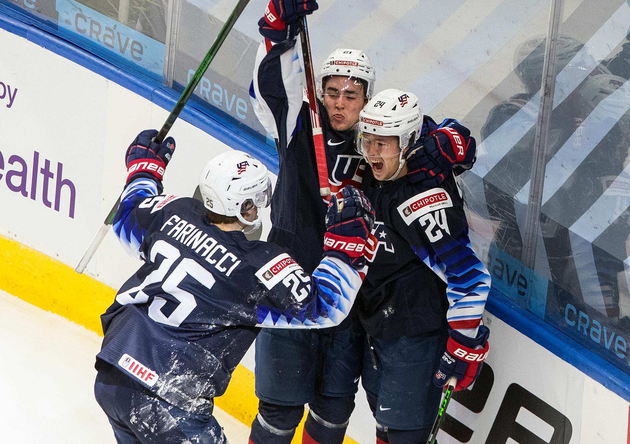 United States' John Farinacci (25), Bobby Brink (24) and Brett Berard (21) celebrate a goal against the Czech Republic on Dec. 29.