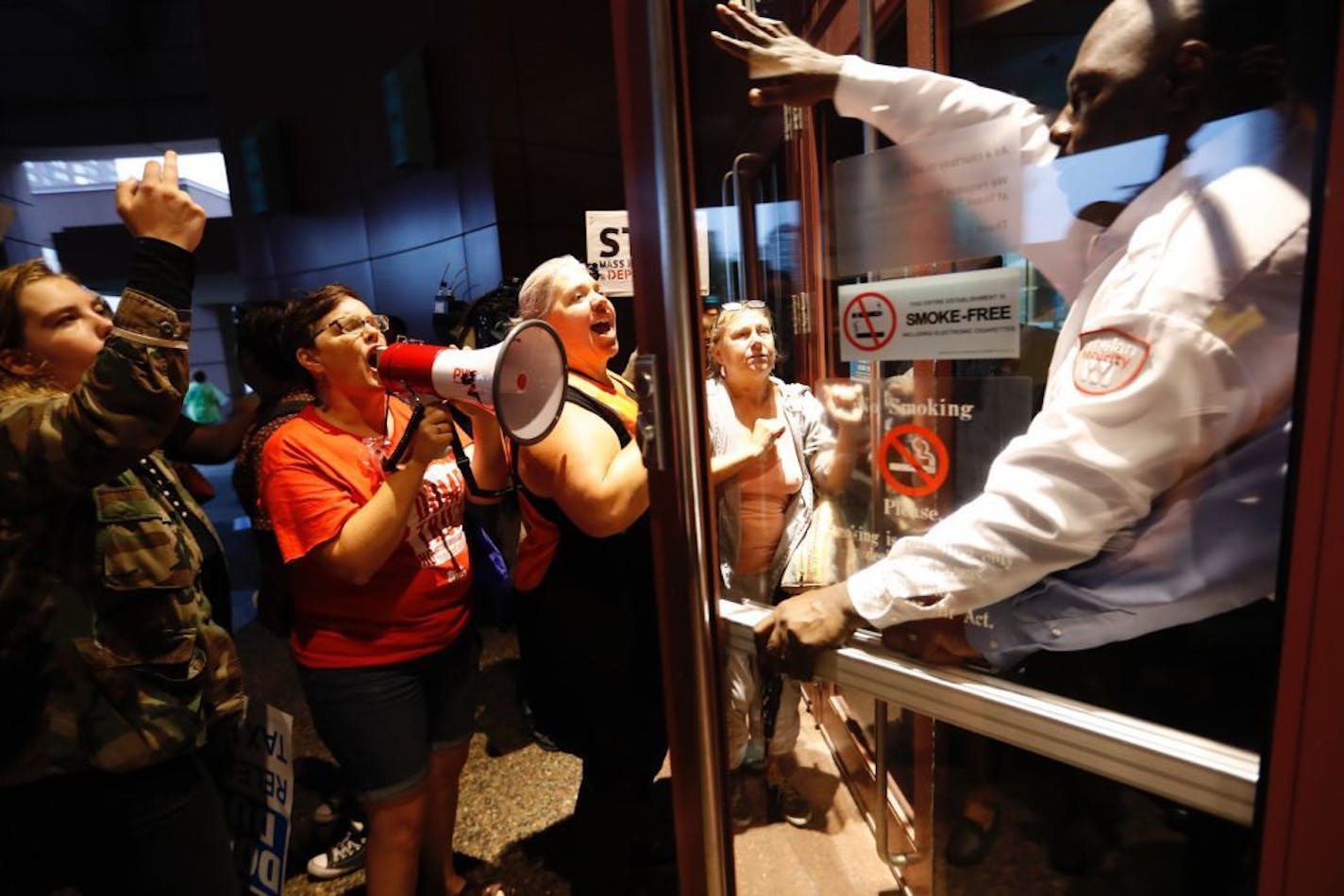 Protesters yelled and crowded a door a security guard was trying to shut after he let in Trump supporters before a fundraiser for republican presidential candidate Donald Trump at the Minneapolis Convention Center on Friday, August 19, 2016 in Minneapolis, Minn.