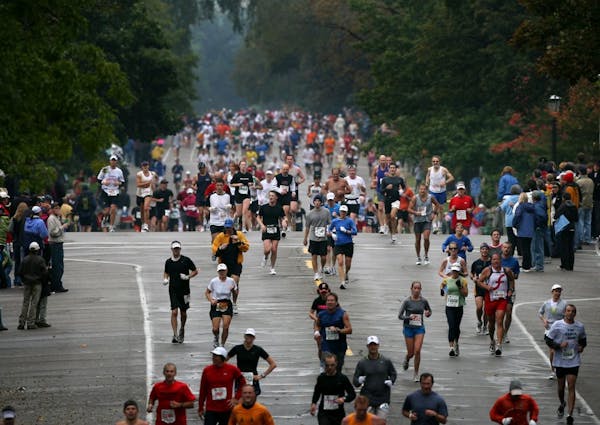 Participants run on Summit Avenue in St. Paul near the 25-mile mark during the Twin Cities Marathon today.