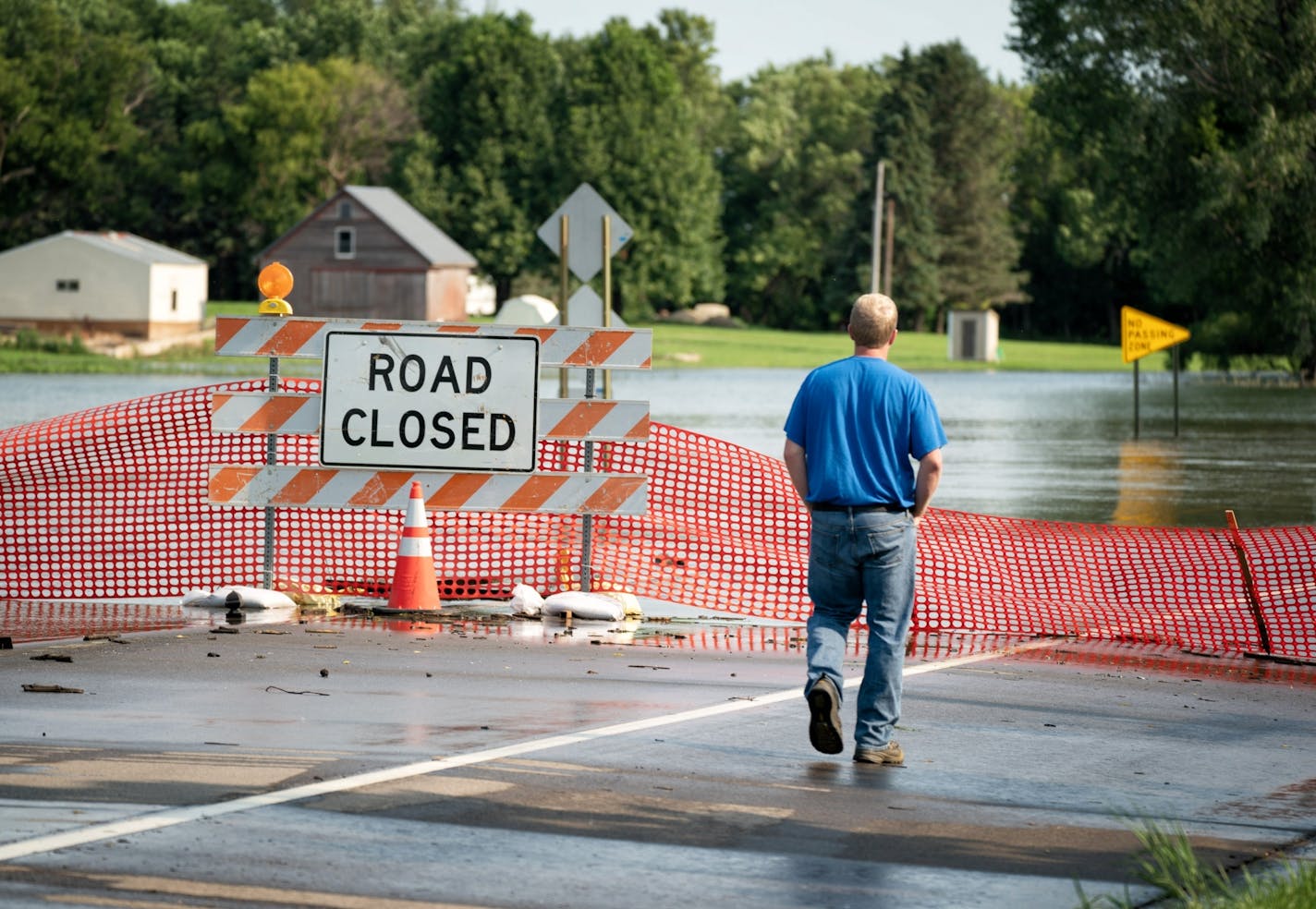 A worker from Northwest Gas inspected gas lines Friday in the flooding in Currie, Minn., in Murray County in southwestern Minnesota. The swollen Des Moines River forced the closure of an main road, 200th Avenue in Currie.