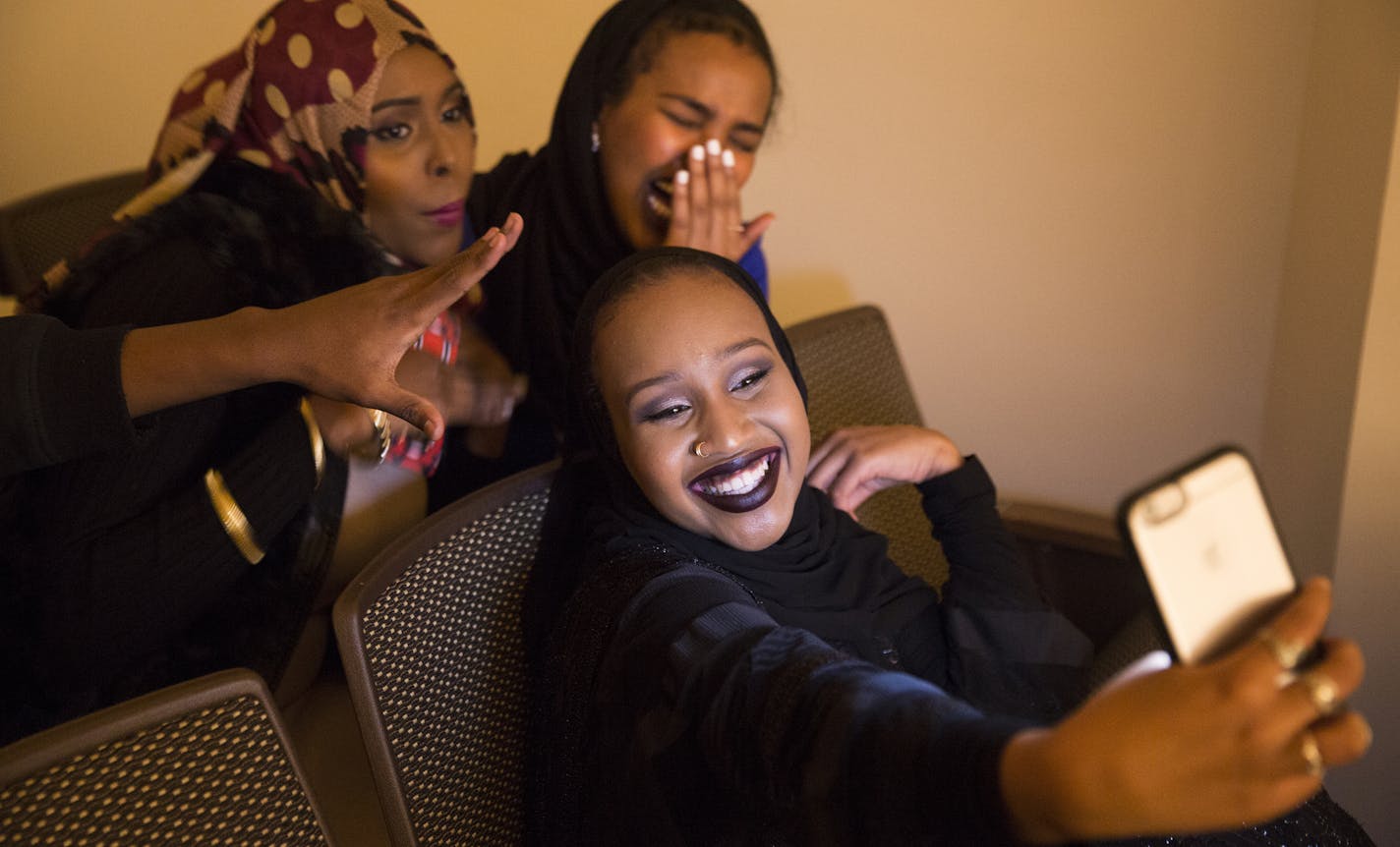 Augsburg students Juweria Hassan, clockwise from bottom, 18, Anisa Ahmed, 18, and Aisha Barre, 19, take a selfie together before walking in a Hijab Fashion Show at Augsburg College in Minneapolis on Wednesday, February 3, 2016. ] (Leila Navidi/Star Tribune) leila.navidi@startribune.com BACKGROUND INFORMATION: Is the 'hijab solidarity' movement an appropriate way to show support for Muslims at a time when so many feel under siege, or is it cultural appropriation? From the professor at a Christian