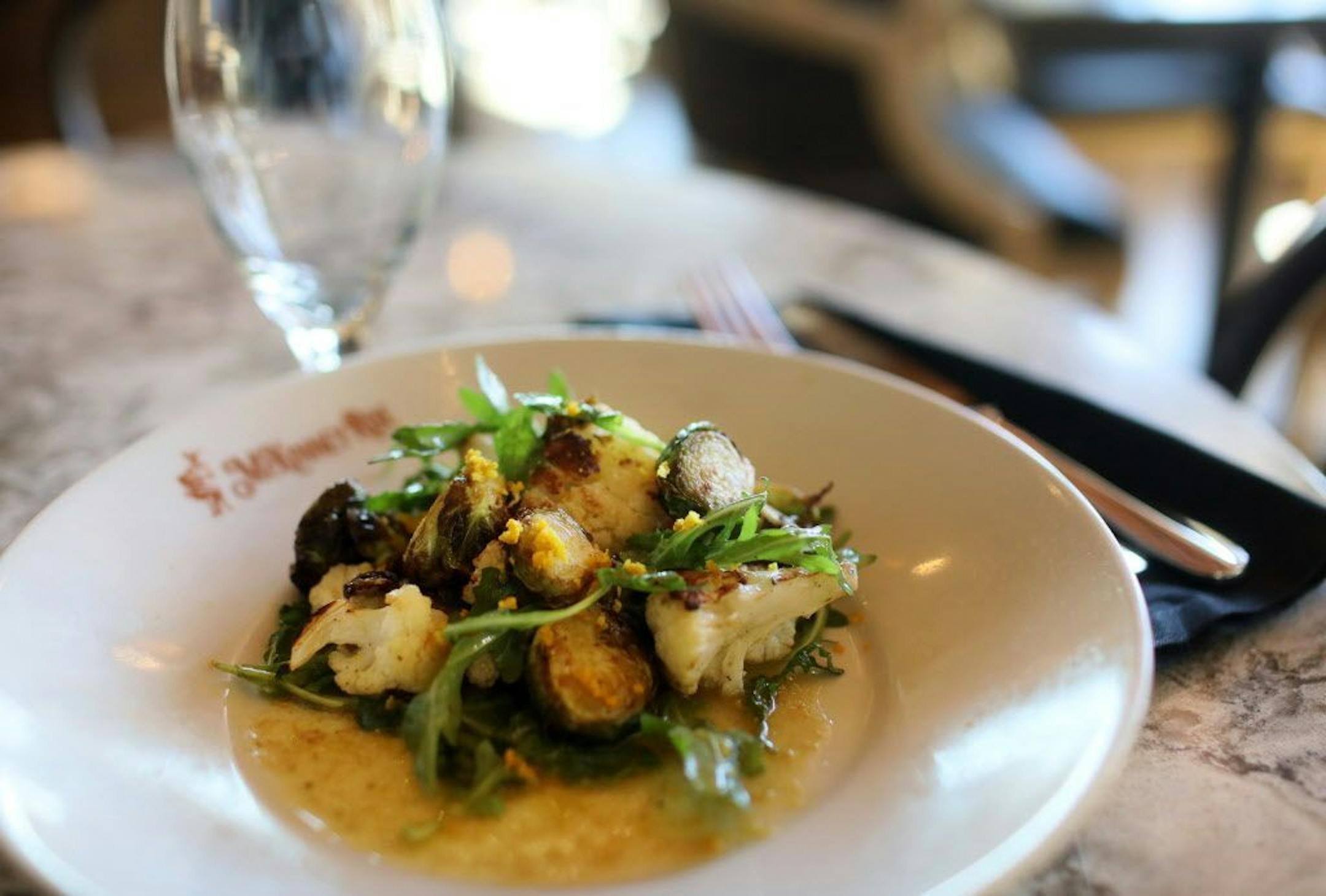 Fried cauliflower and Brussel sprout salad at McKinney Roe with arugula, fried capers, tarragon, orange and sherry vinaigrette Thursday, Nov. 1, 2018, in Minneapolis, MN.