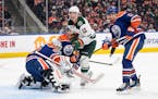 The Wild's Matt Boldy looked for the rebound in front of Oilers goalie Calvin Pickard as Cody Ceci (5) defended during the first period Friday.