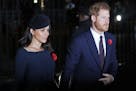 Meghan, Duchess of Sussex, left, and Prince Harry arrive at Westminster Abbey to attend the National Service to mark the Centenary of the Armistice in