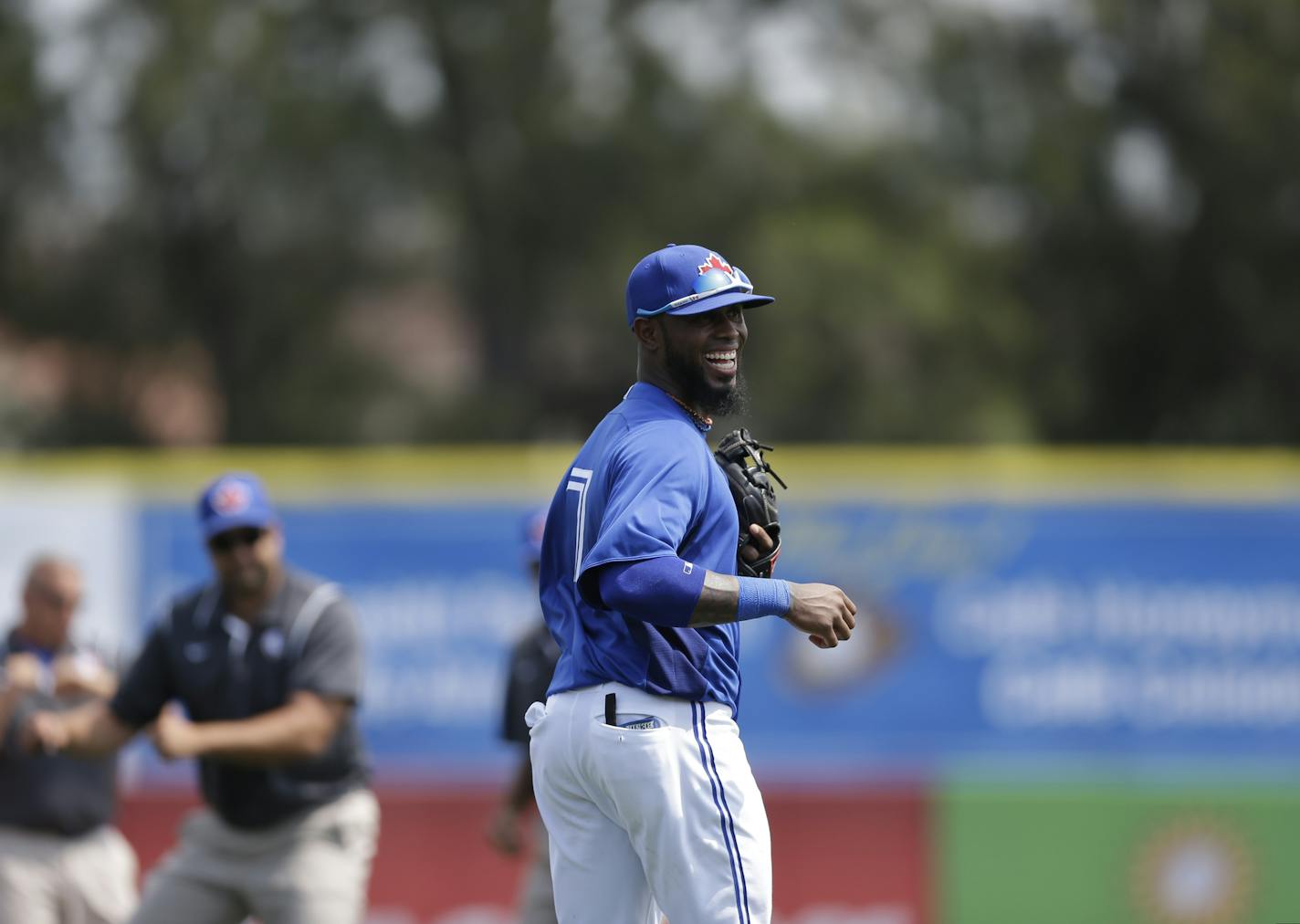 Toronto Blue Jays shortstop Jose Reyes (7) reacts watching grounds crew members do the Harlem Shuffle between innings in a spring training baseball game in Dunedin, Fla., Saturday, March 23, 2013. (AP Photo/Kathy Willens)