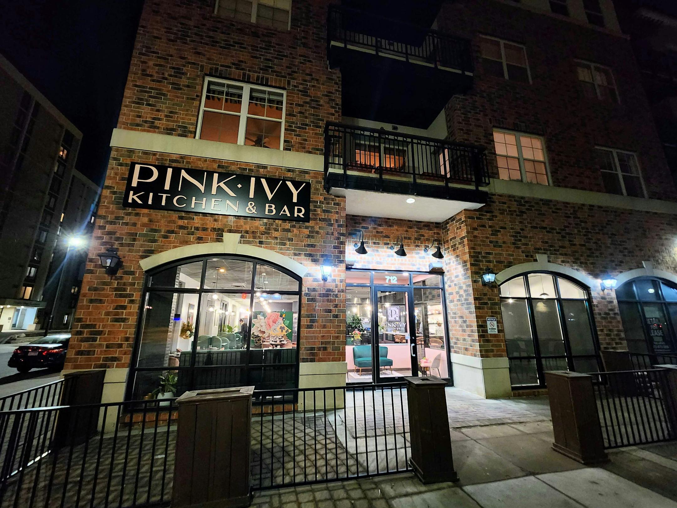 The brick façade with a sign that says Pink Ivy Kitchen & Bar