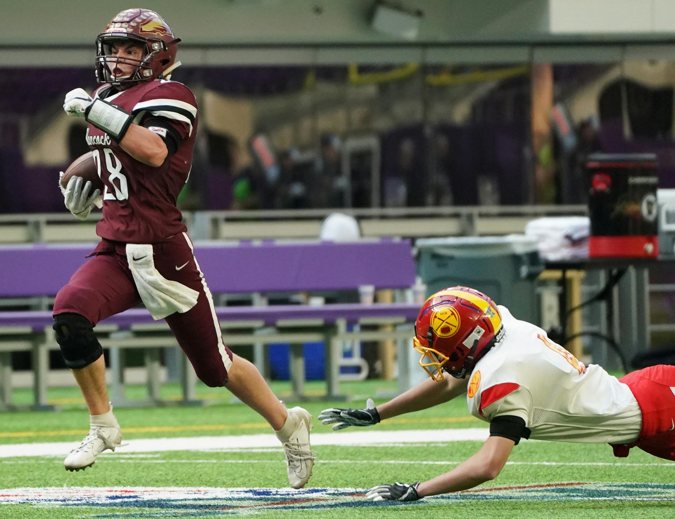 Hancock running back Tyler TImmerman (28) returned a kick 75 yards for a touchdown in the second quarter as Mountain Iron-Buhl's Mason Clines (4) attempted a tackle. ] Shari L. Gross • shari.gross@startribune.com Hancock led Mountain Iron-Buhl 30-14 at the half in a 9-man semifinal game at the state tournament inside U.S. Bank Stadium in Minneapolis, Minn. on Thursday, Nov. 14, 2019. 9-Man: Mountain Iron-Buhl vs. Hancock, 11:30am Class 2A: Paynesville vs. Mpls North, 2pm