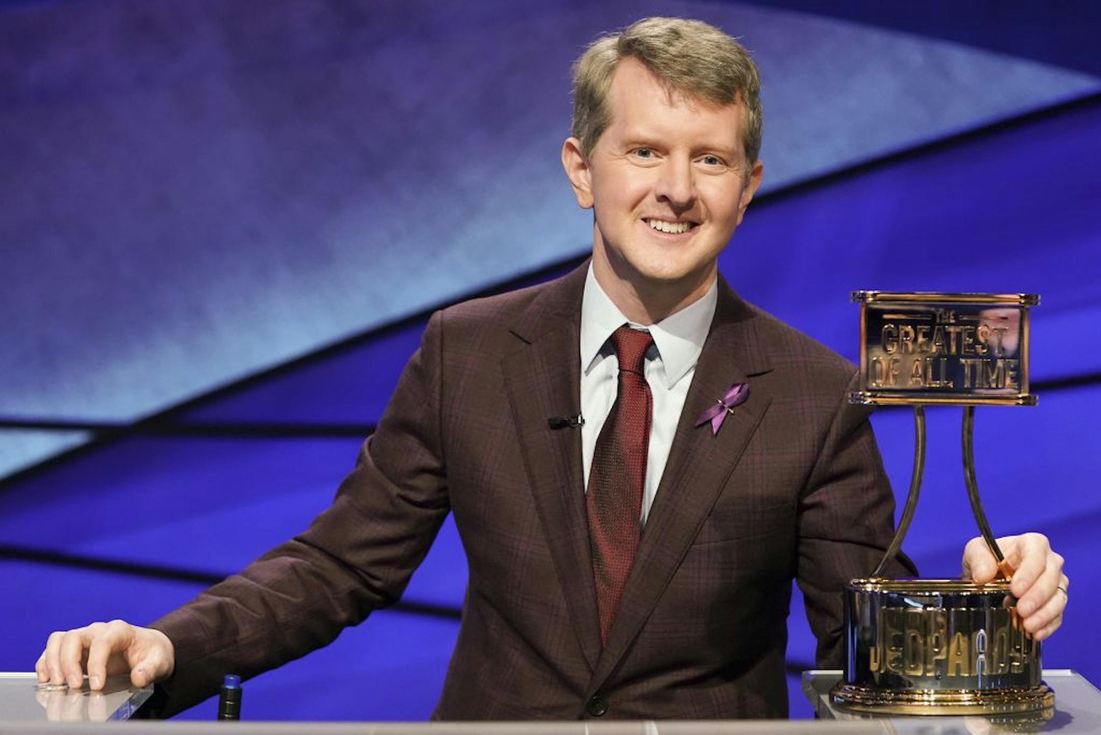 This image released by ABS shows contestant Ken Jennings with a trophy on "Jeopardy! The Greatest of All Time." Jennings will be the first interim guest for the late Alex Trebek, and the show will try other guest hosts before naming a permanent replacement.