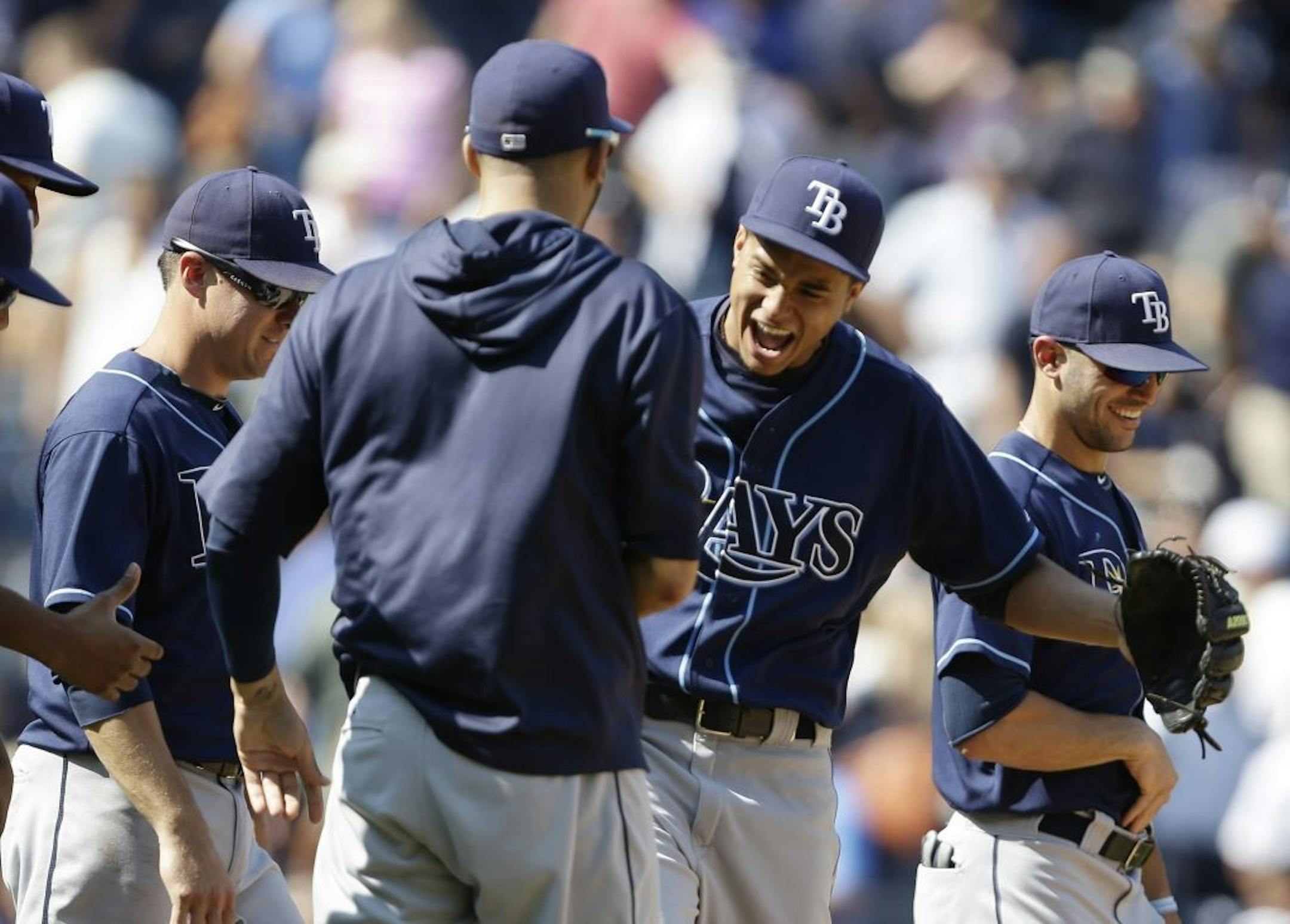 Tampa Bay Rays starting pitcher Chris Archer, second from right, celebrates with teammates after throwing a complete baseball game in their 1-0 win over the the New York Yankees Saturday, July 27, 2013, in New York.