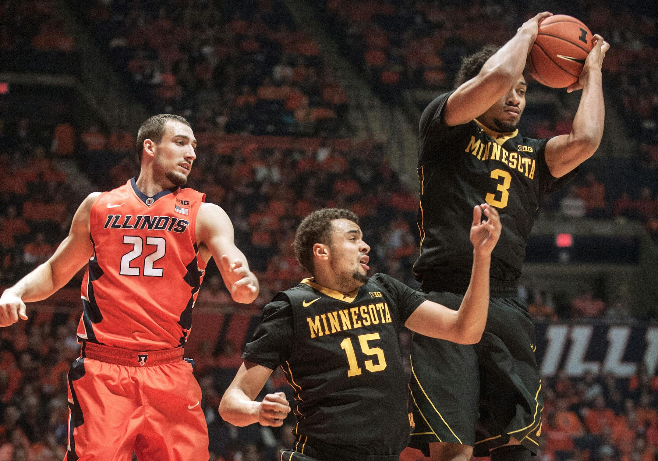 Minnesota forward Jordan Murphy (3) grabs a rebound away from Minnesota guard Stephon Sharp (15) and Illinois center Maverick Morgan (22) in the first half of an NCAA college basketball game at the State Farm Center in Champaign, Ill., on Sunday, Feb. 28, 2016. (AP Photo/Rick Danzl)