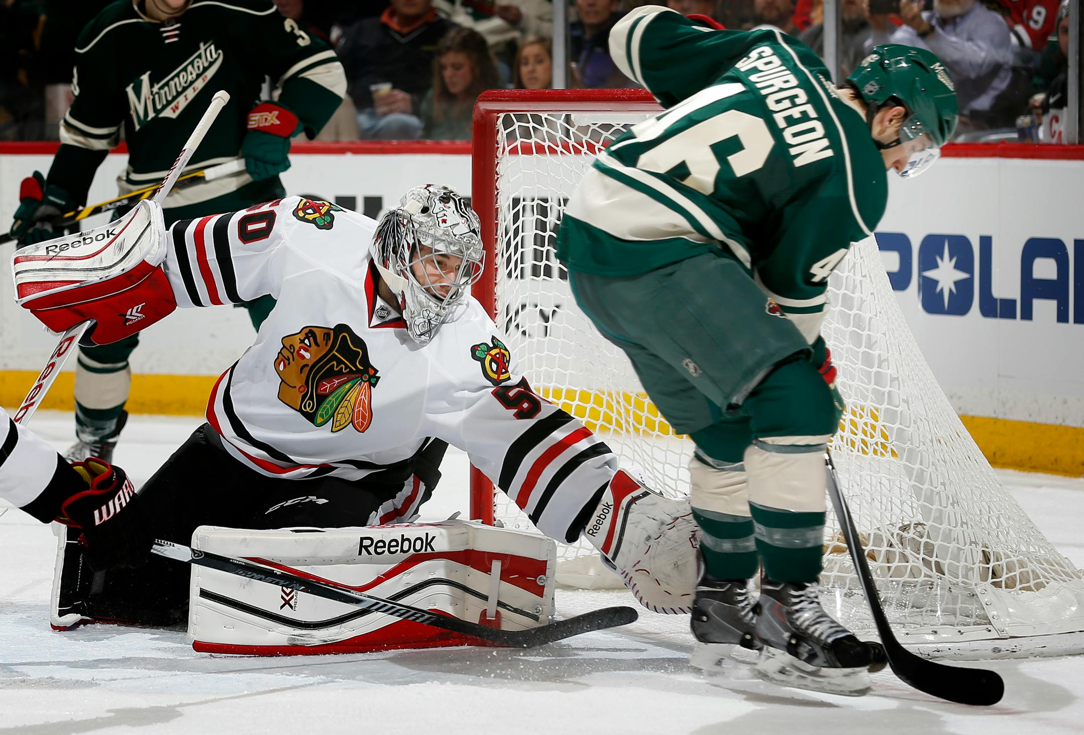 Blackhawks goalie Corey Crawford reacted to a shot by the Wild's Jared Spurgeon (46).